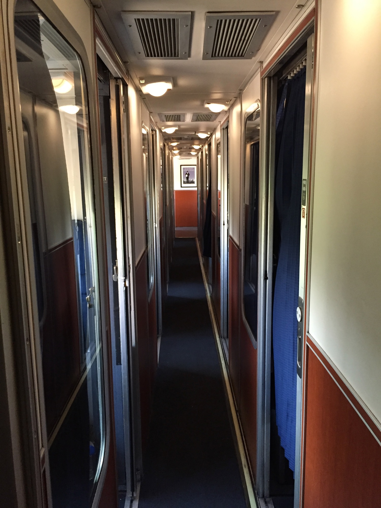 a long hallway with doors and windows