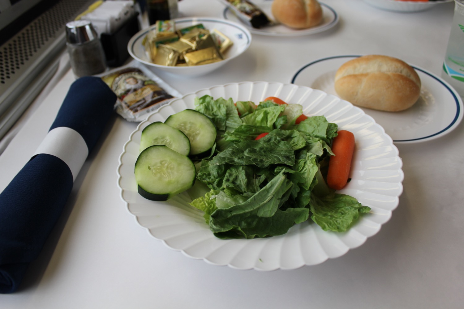 a plate of salad and vegetables on a table