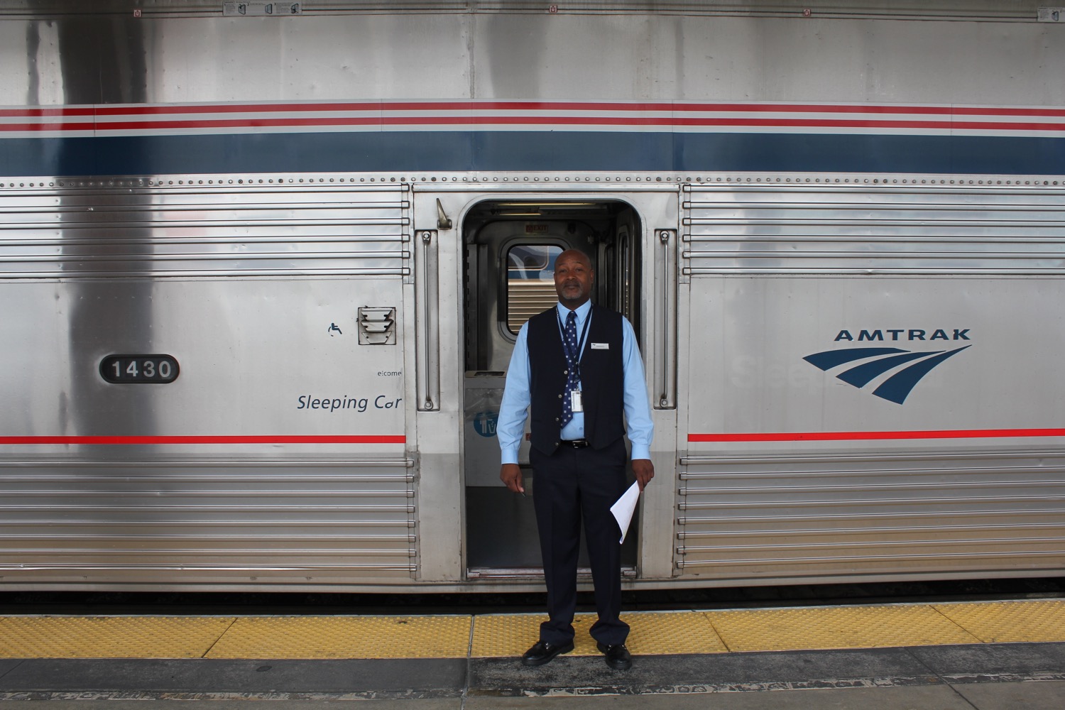 a man standing in front of a train