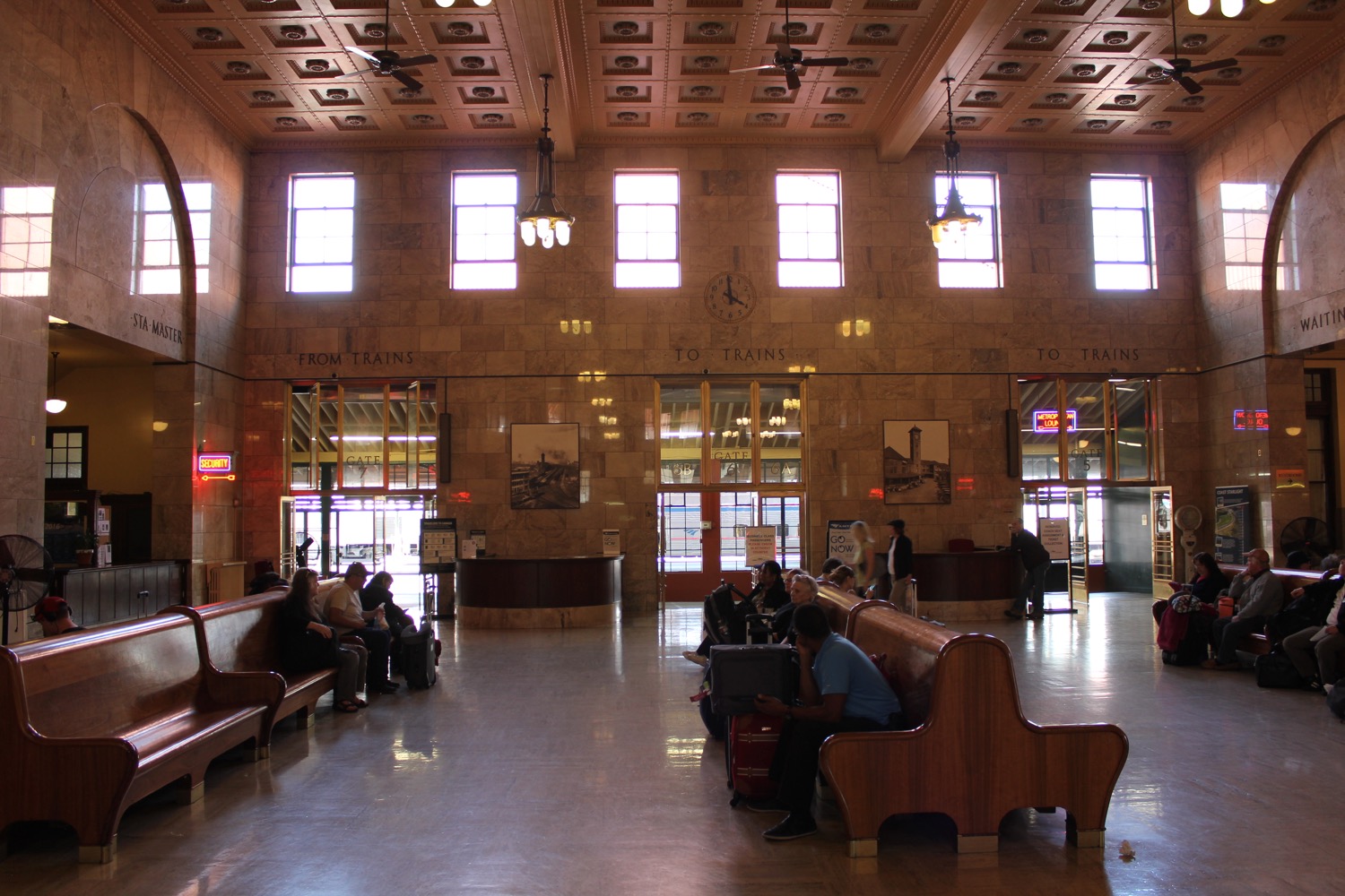 people sitting on benches in a train station