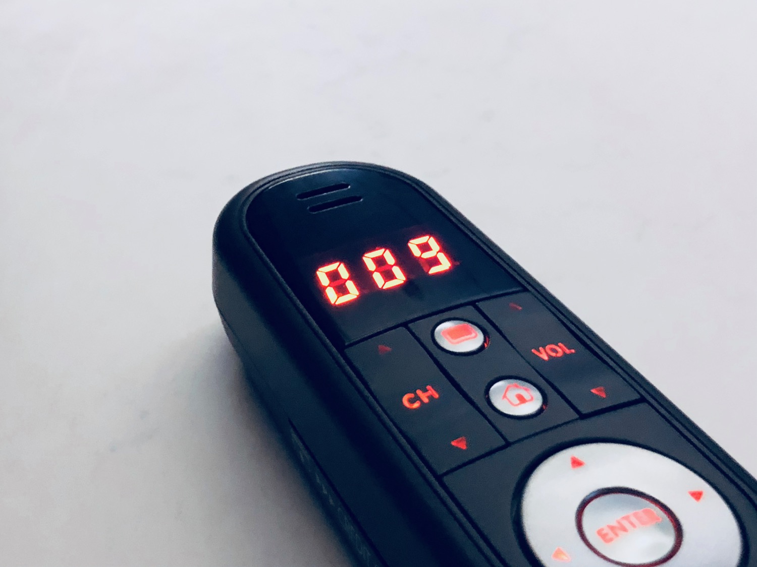 a remote control with red numbers