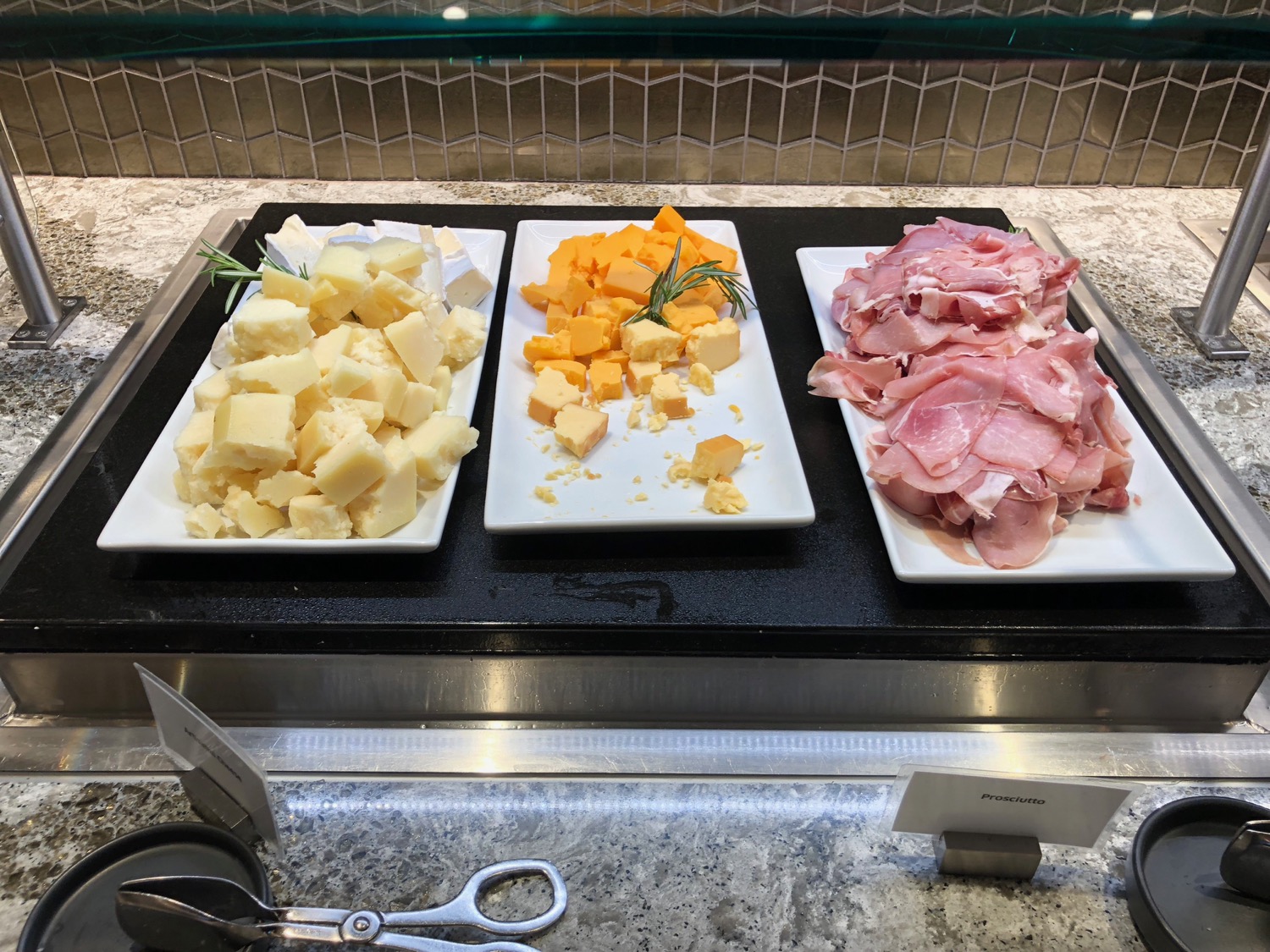 a trays of different types of cheese and meat