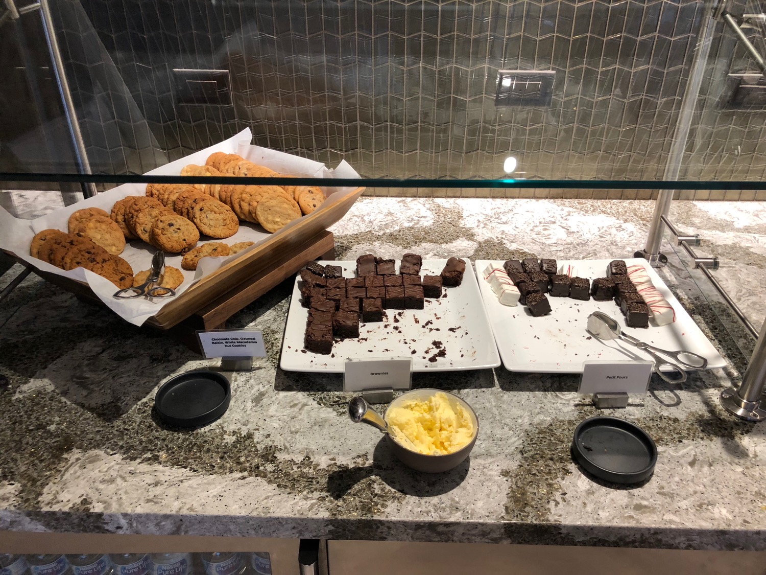 a display case with different kinds of cookies and brownies