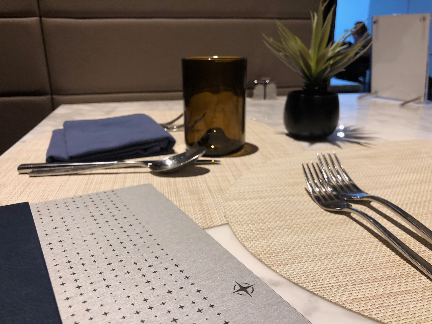 a table with silverware and a glass on it