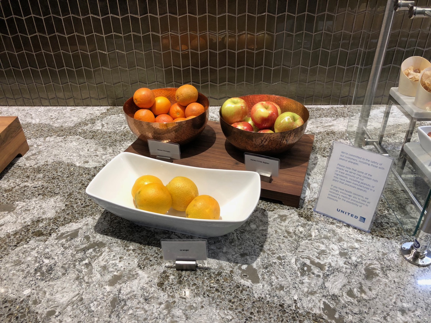a group of bowls of fruit on a counter