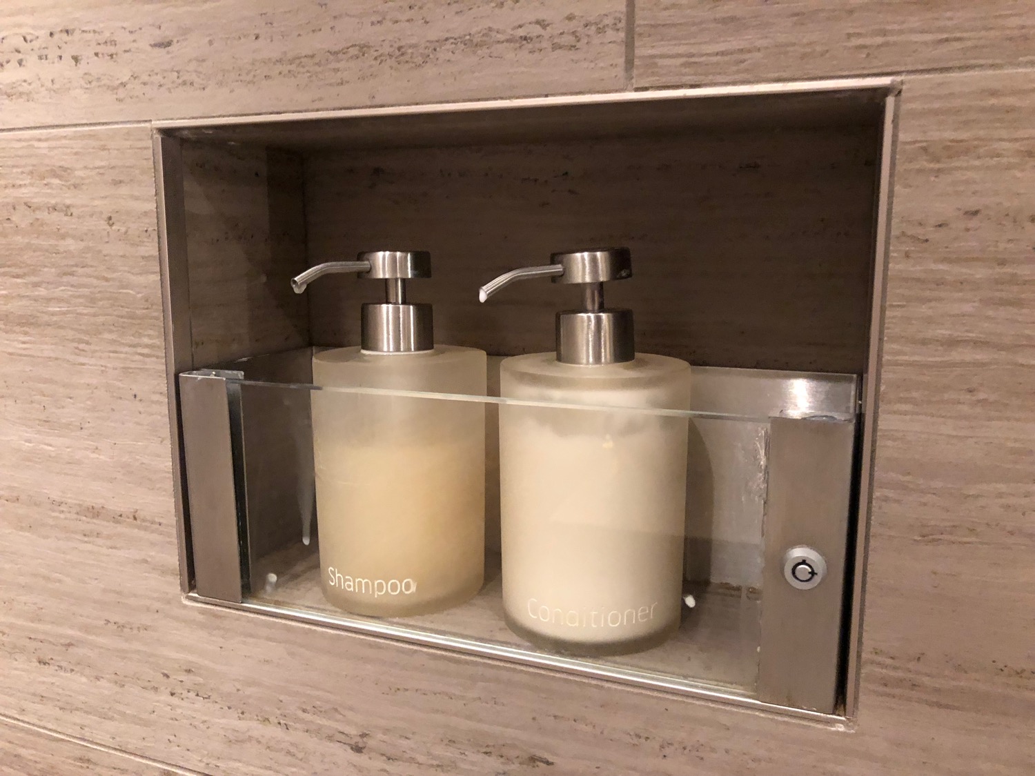 a group of soap dispensers in a shelf
