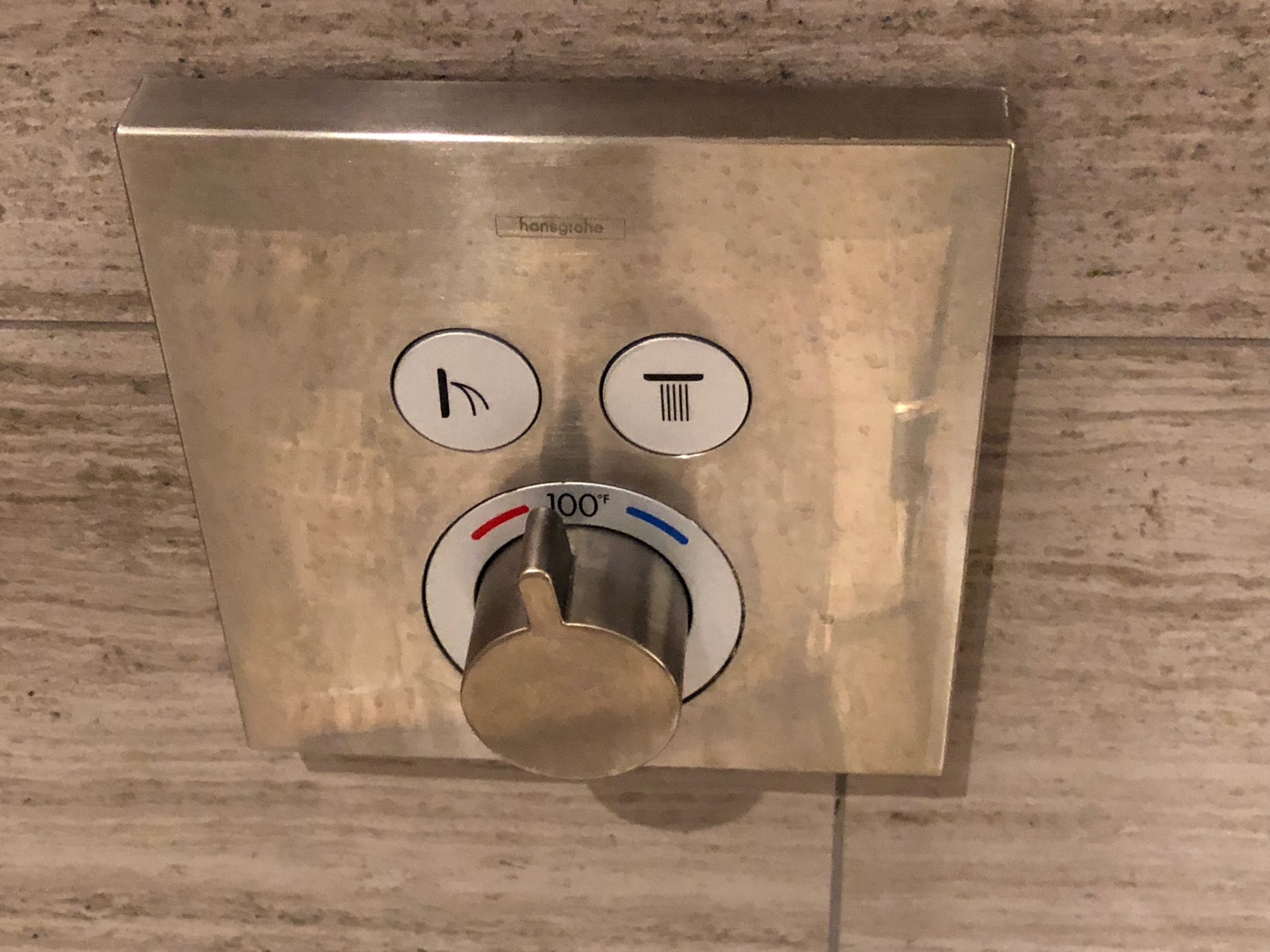 a metal panel with knob on the wall