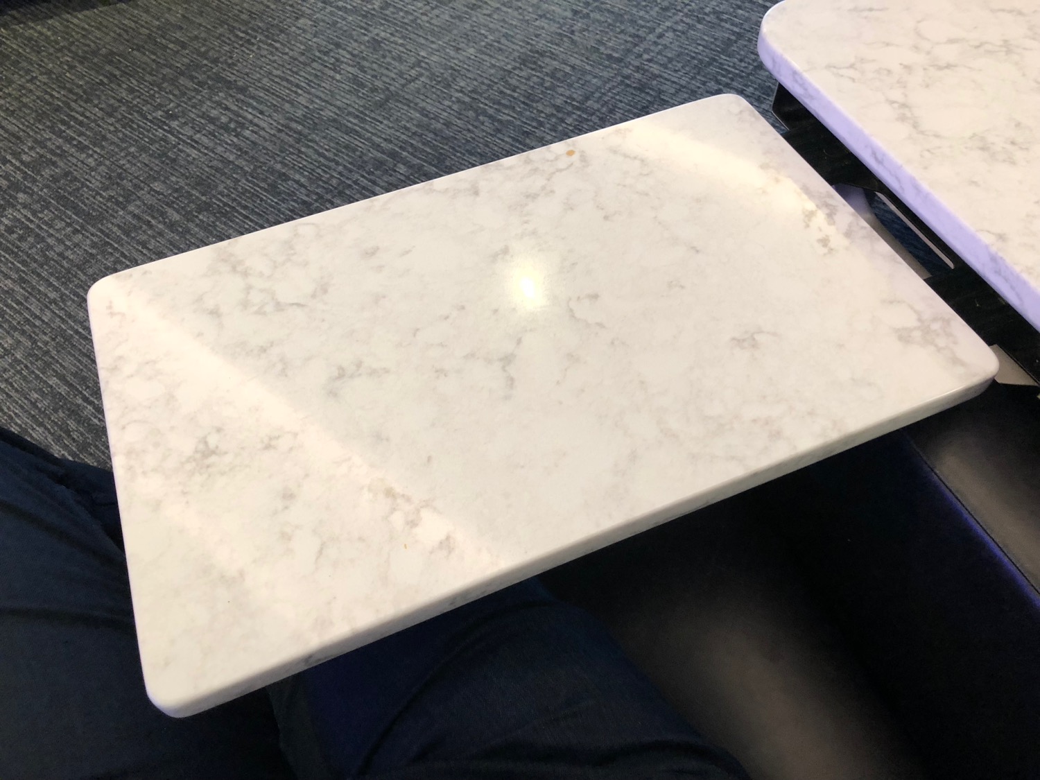 a white rectangular table on a person's lap