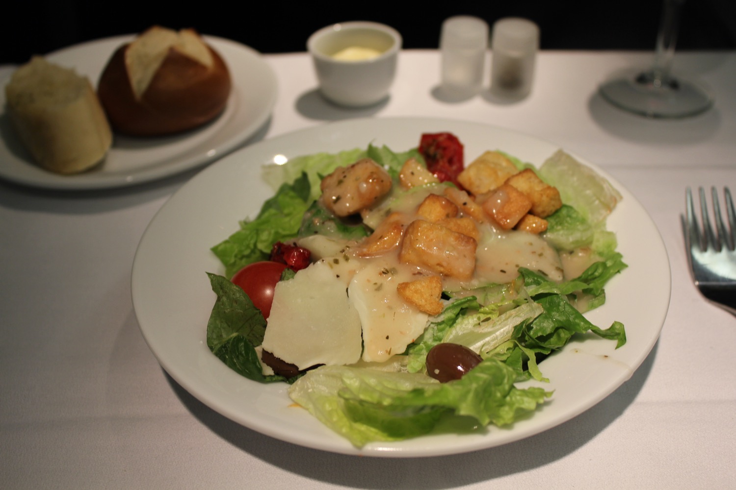 a plate of salad with croutons and cheese