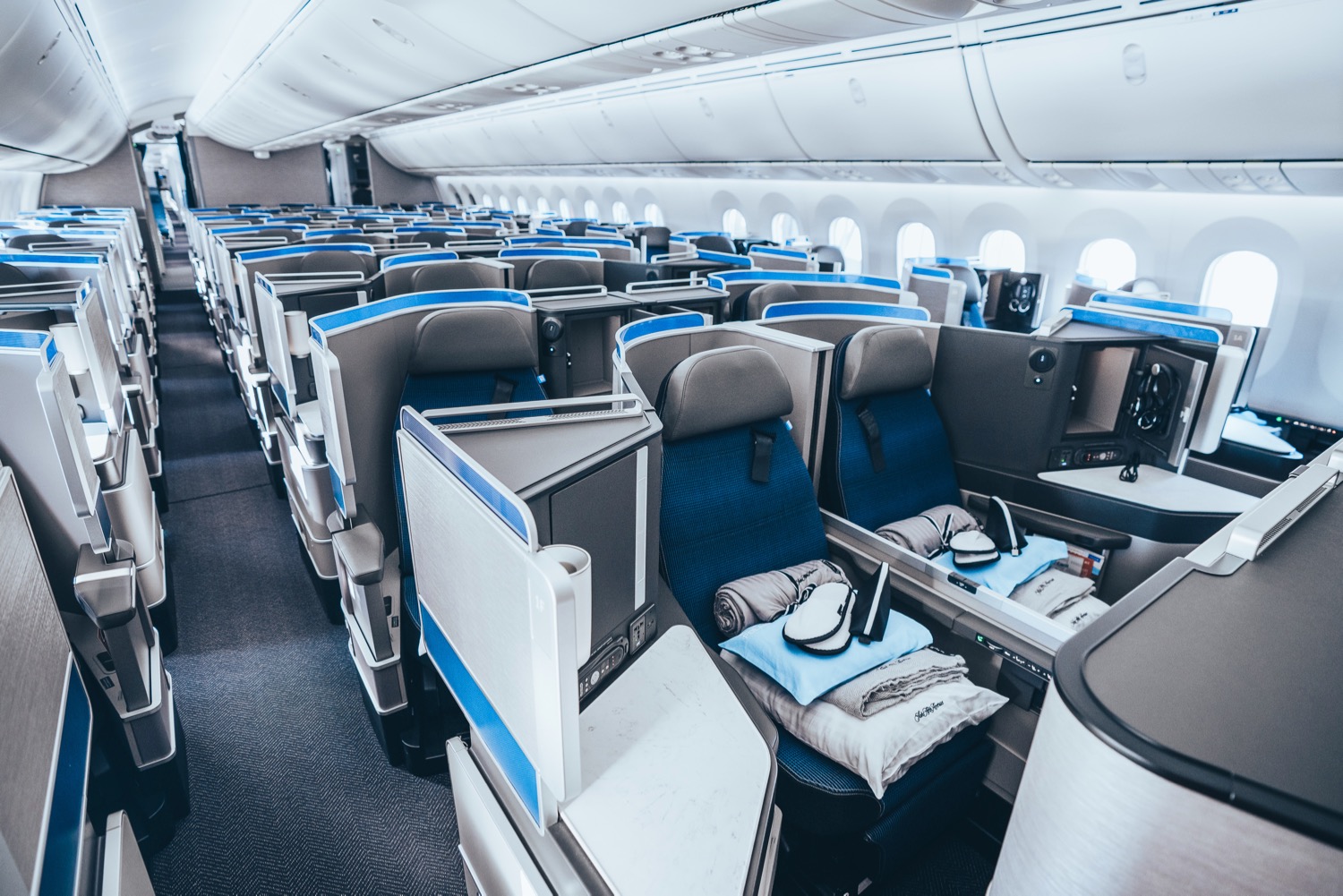 an airplane seats with blue seats and white seats