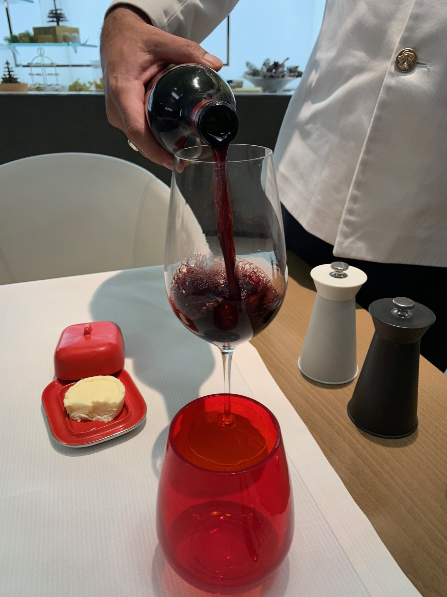 a person pouring wine into a glass
