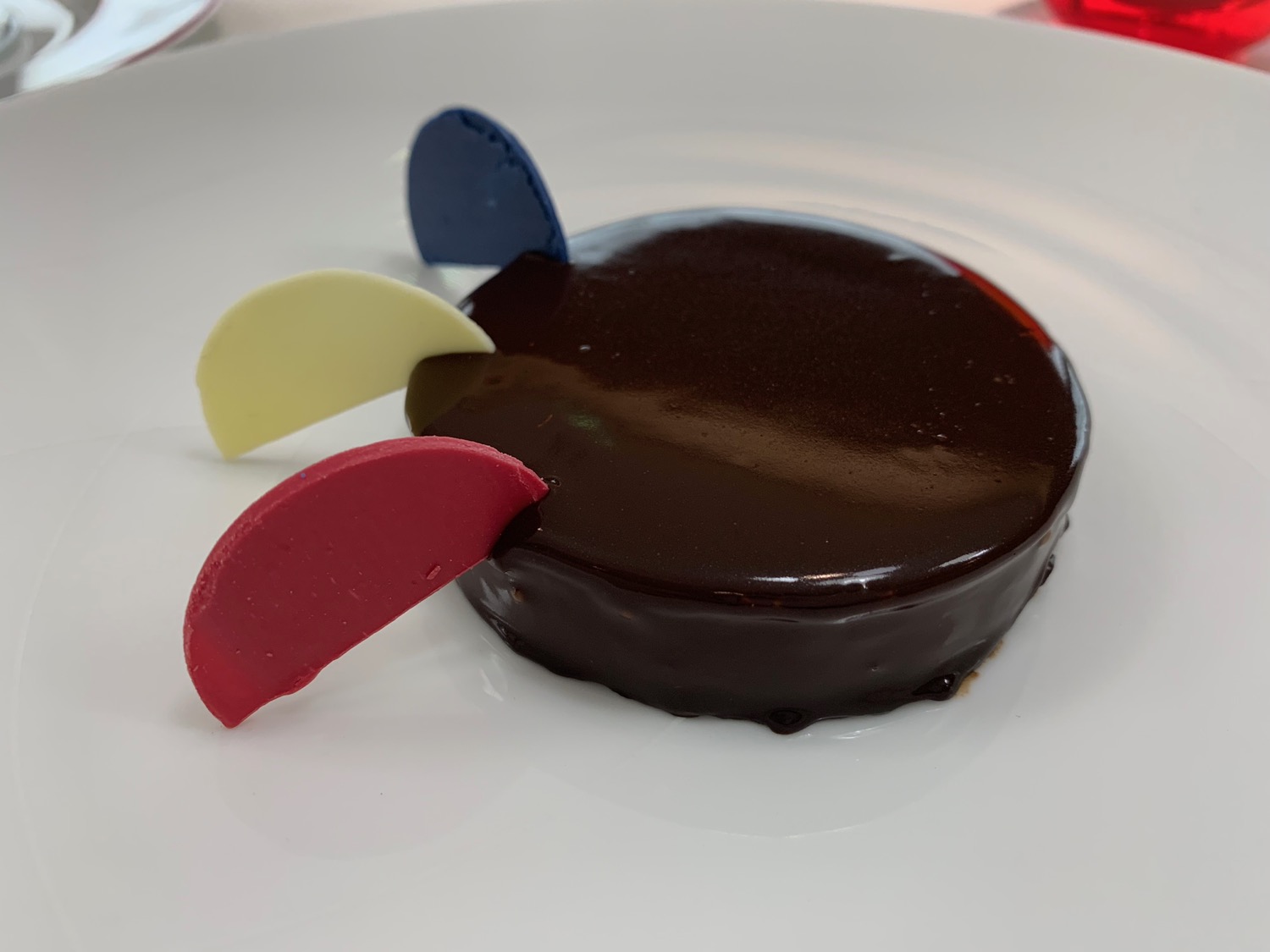 a chocolate cake with colorful toppings on a white plate