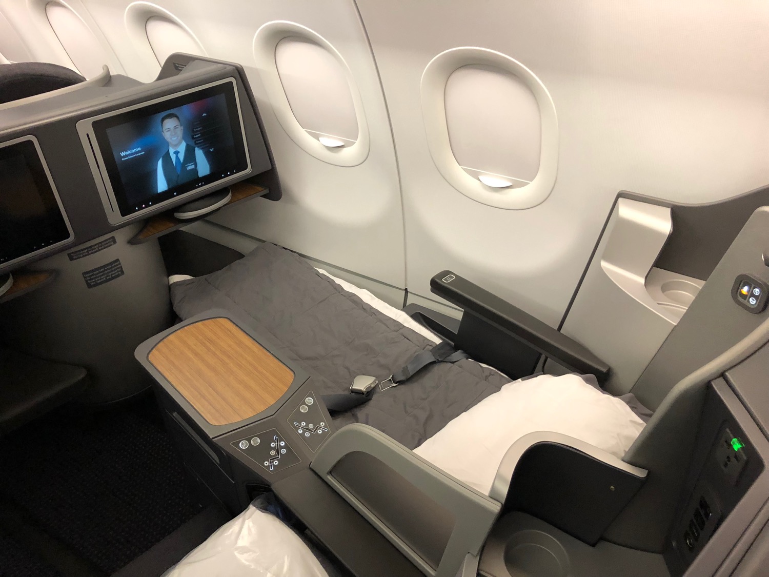 a bed and a tv in an airplane