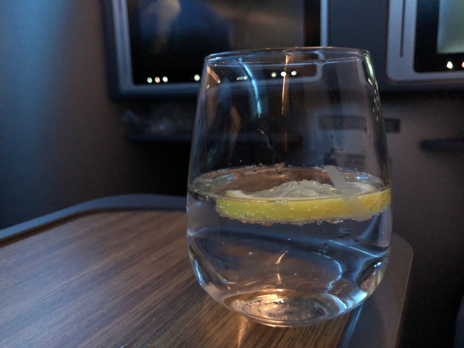 a glass of water with a lemon slice in it