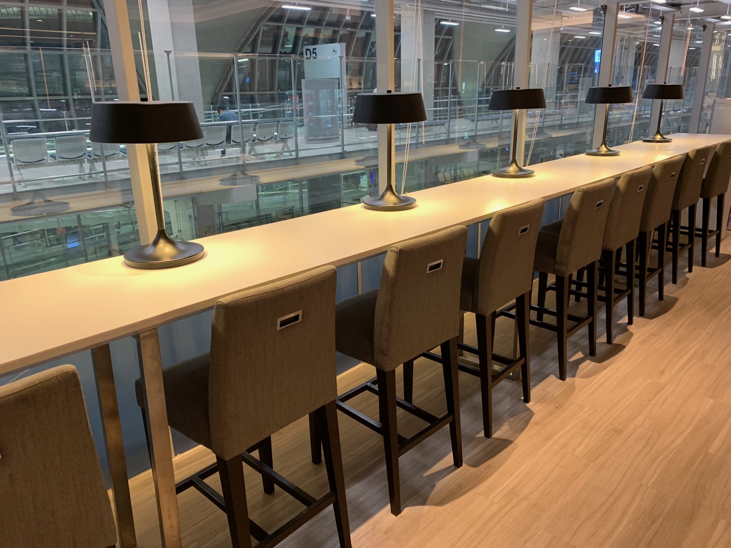 a row of chairs and a table with lamps on it