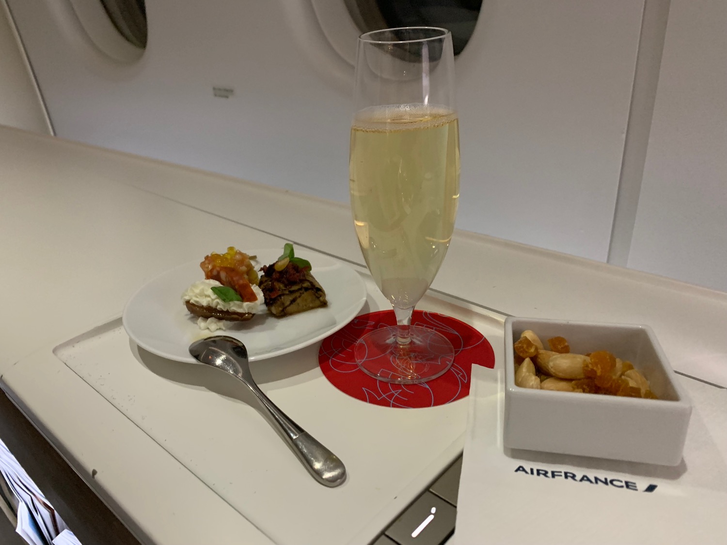 a glass of champagne and food on a plate