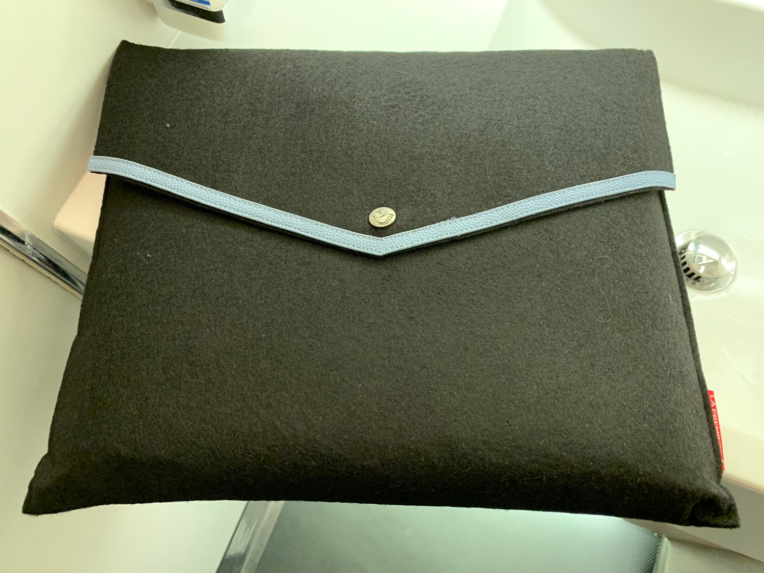 a black bag with a blue strap