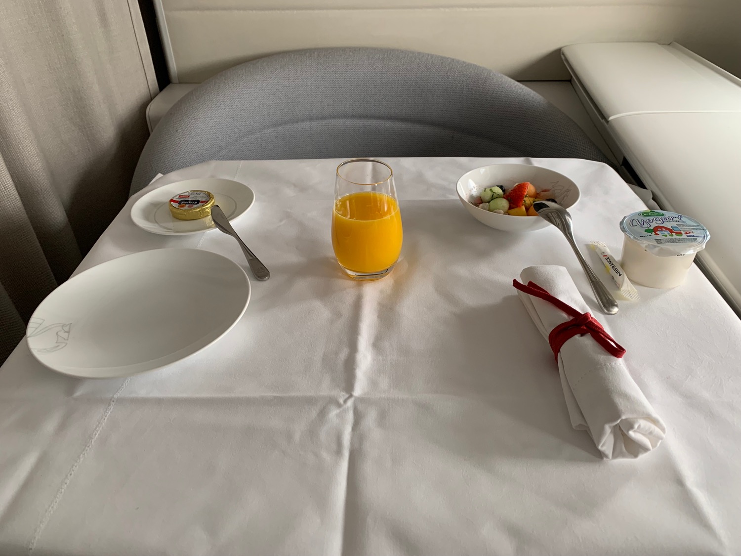 a table with food and a glass of orange juice