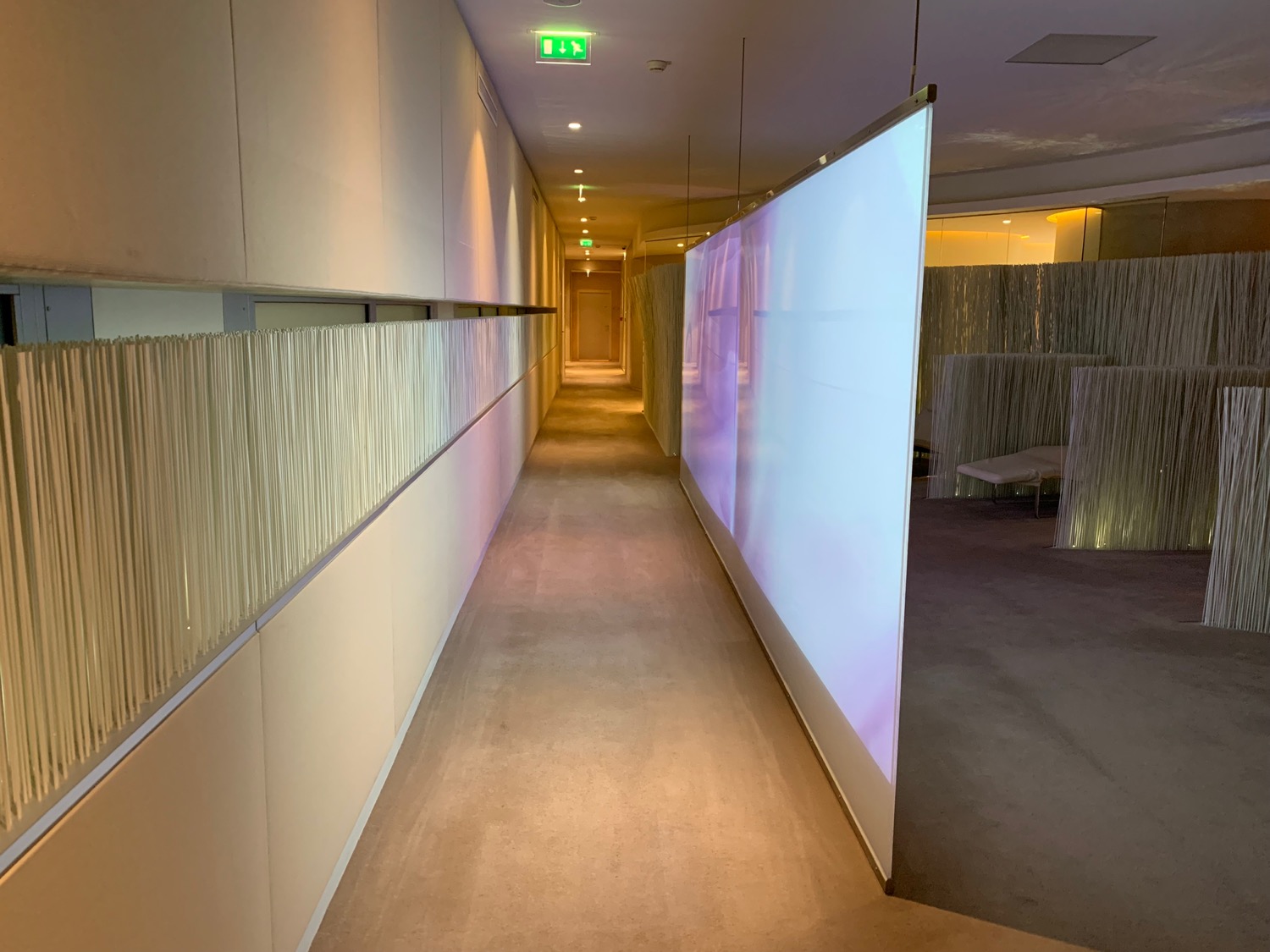 a long hallway with a large screen
