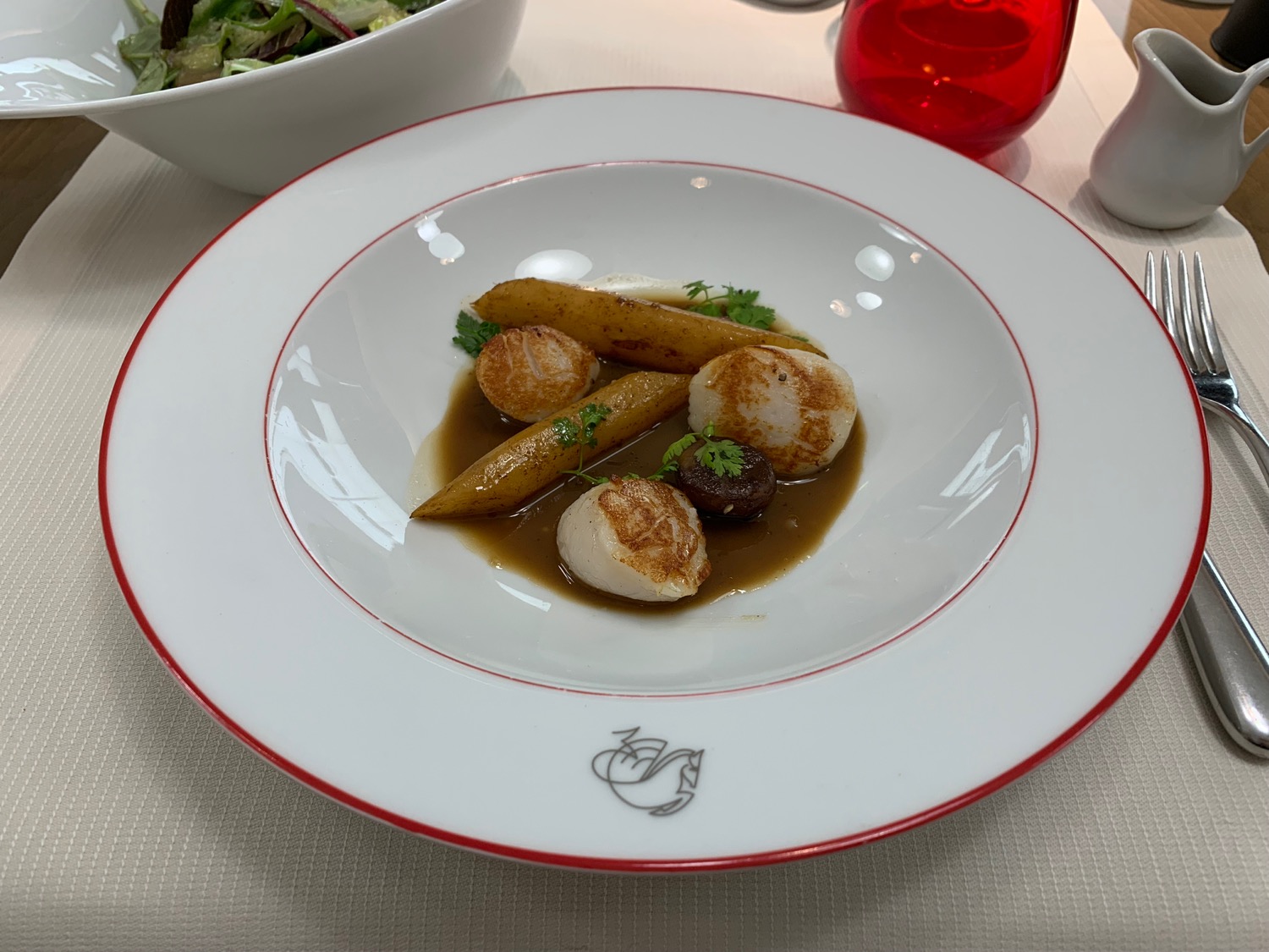a plate of scallops and vegetables