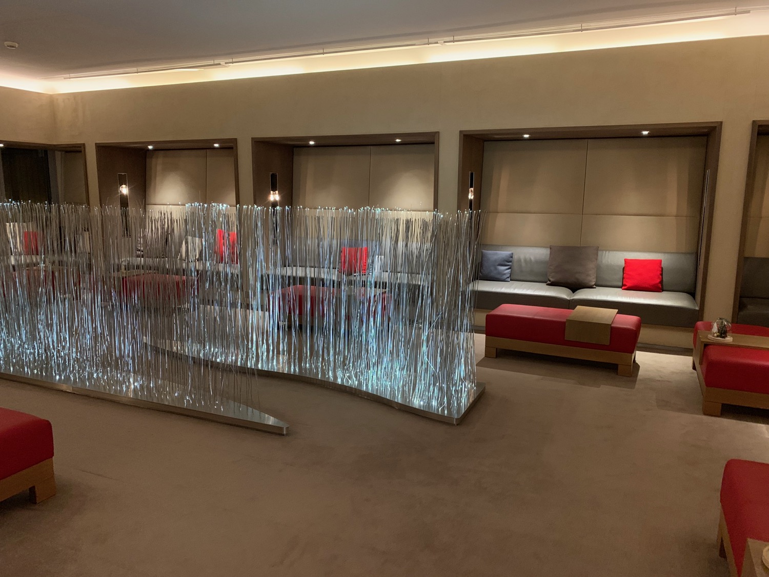 a room with a glass wall and a couch