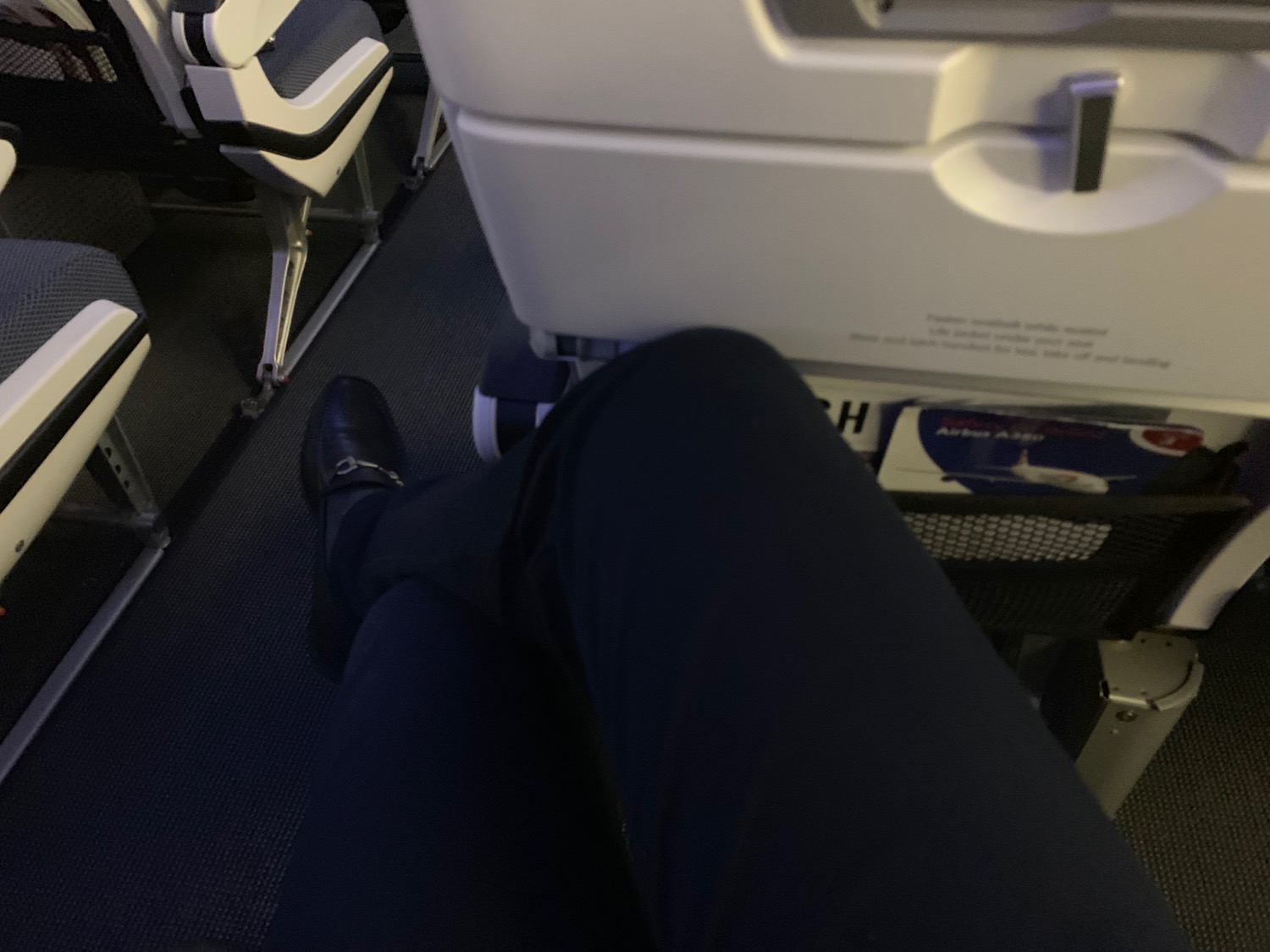 a person's leg and leg in an airplane