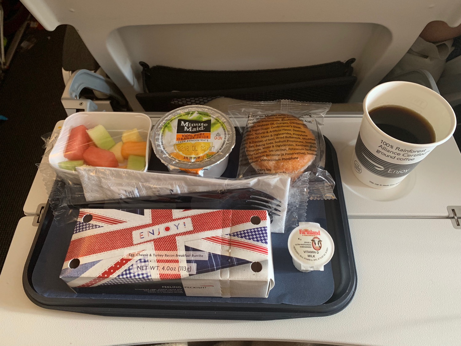 a tray with food and a cup of coffee on a table