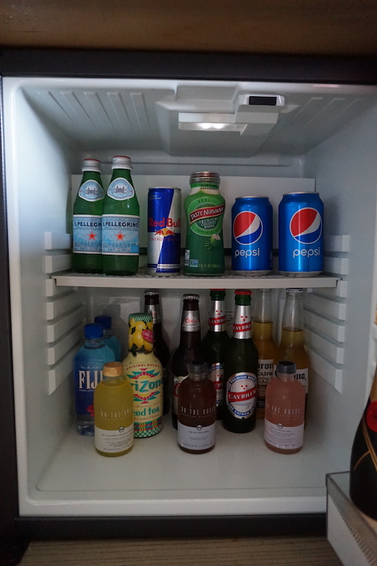 mini bar with limited space for guest beverages or water