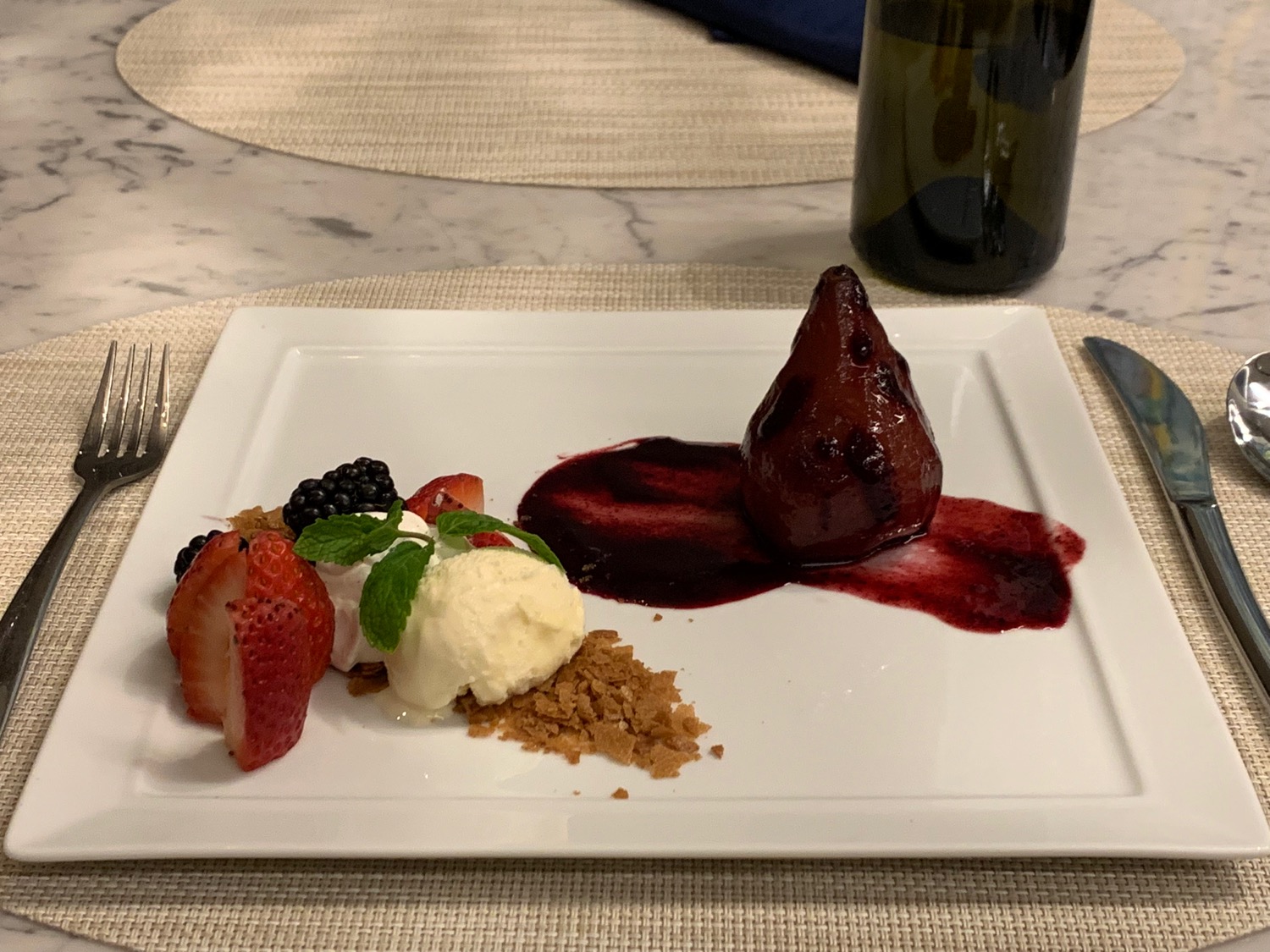 a plate of dessert with fruit and ice cream