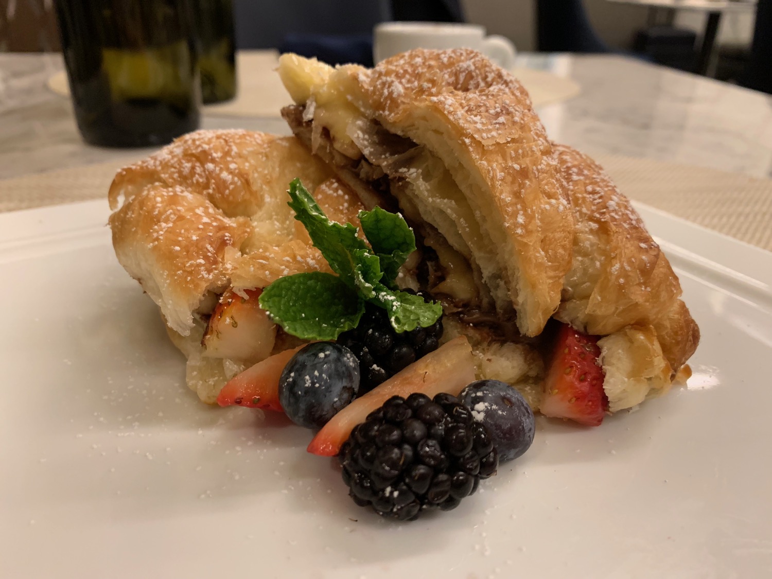 a croissant with fruit on a plate