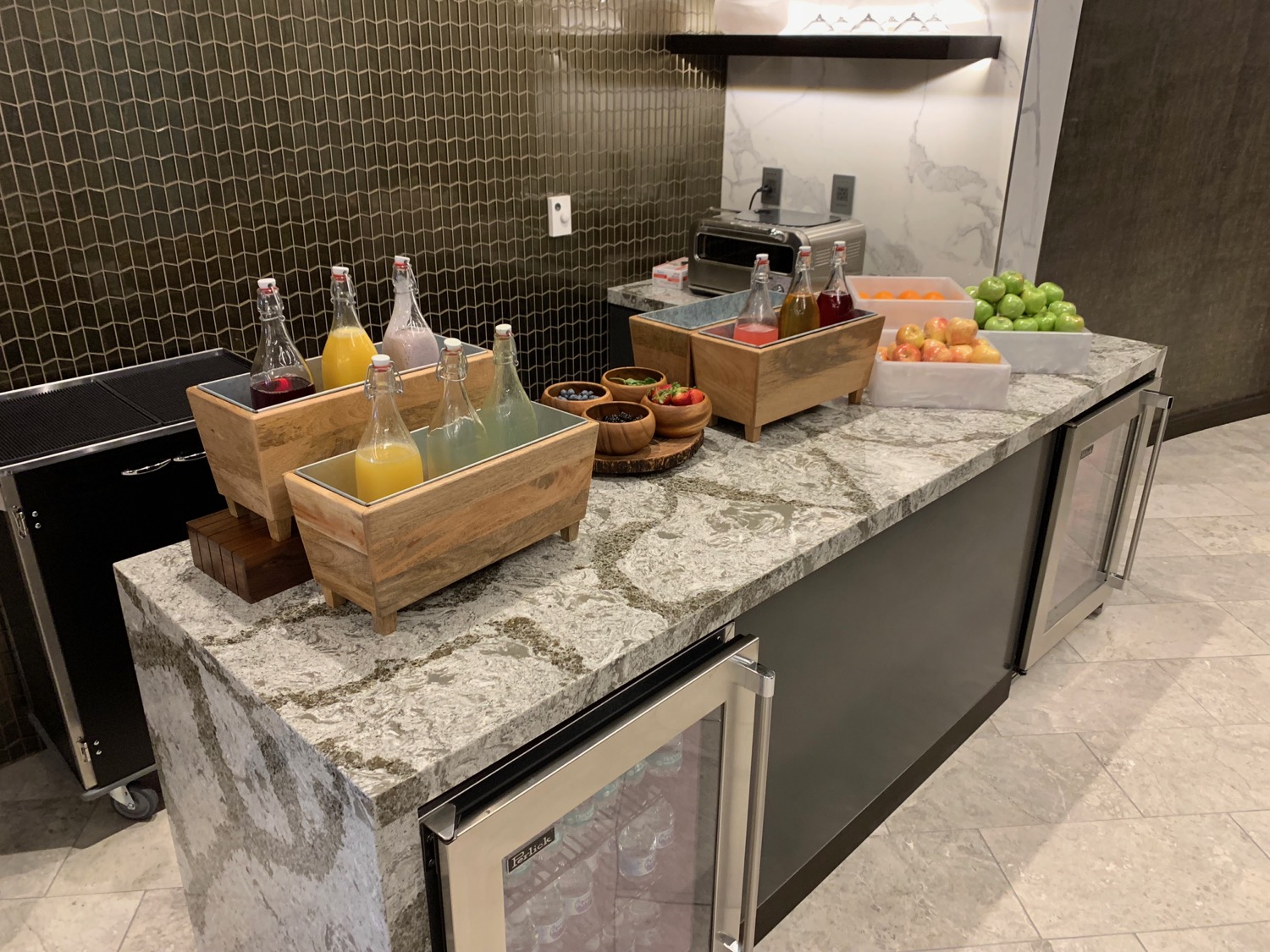 a counter with fruit and juice in containers