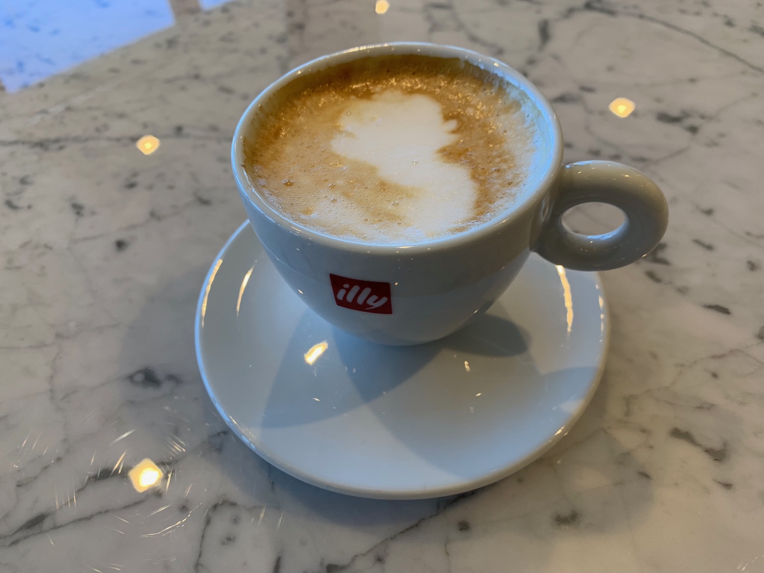 a cup of coffee on a marble table