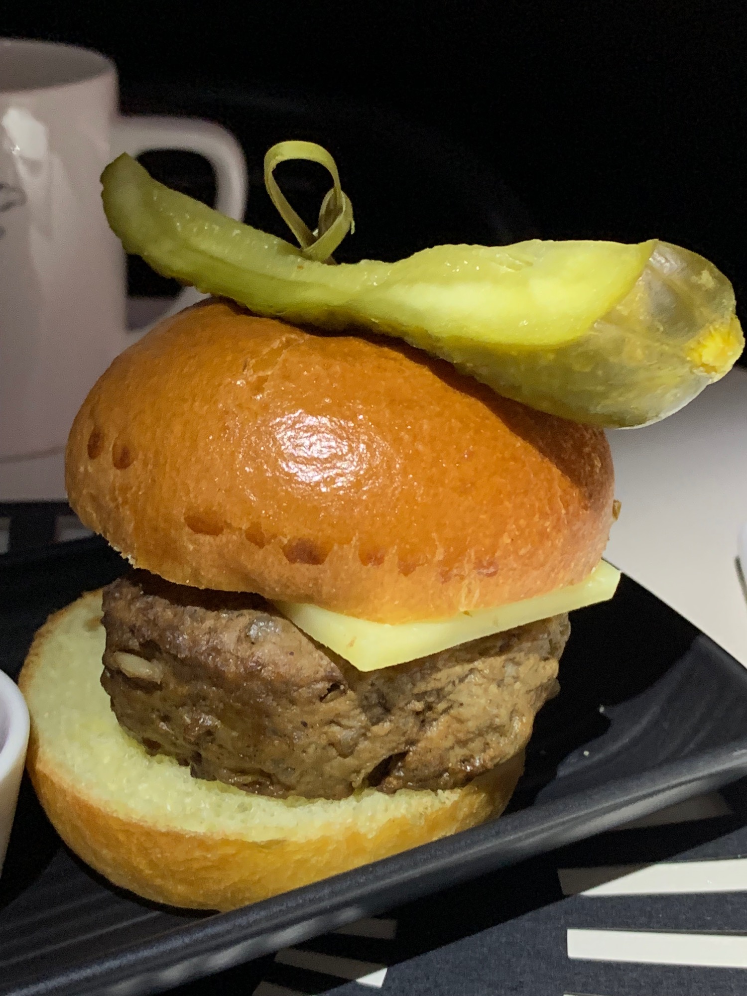 a burger with a pickle on top