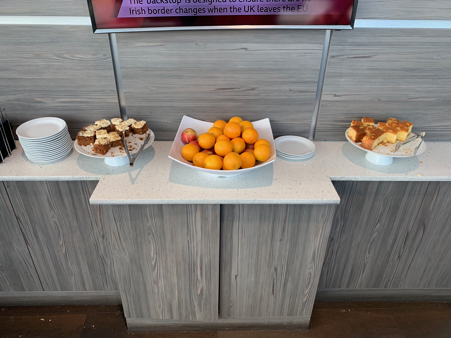 a plate of oranges and cakes on a counter