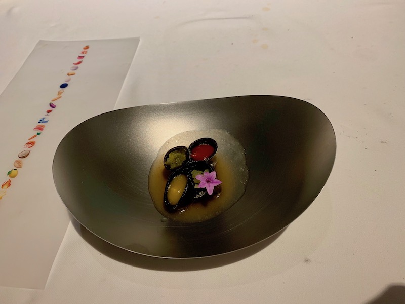 a metal bowl with food in it