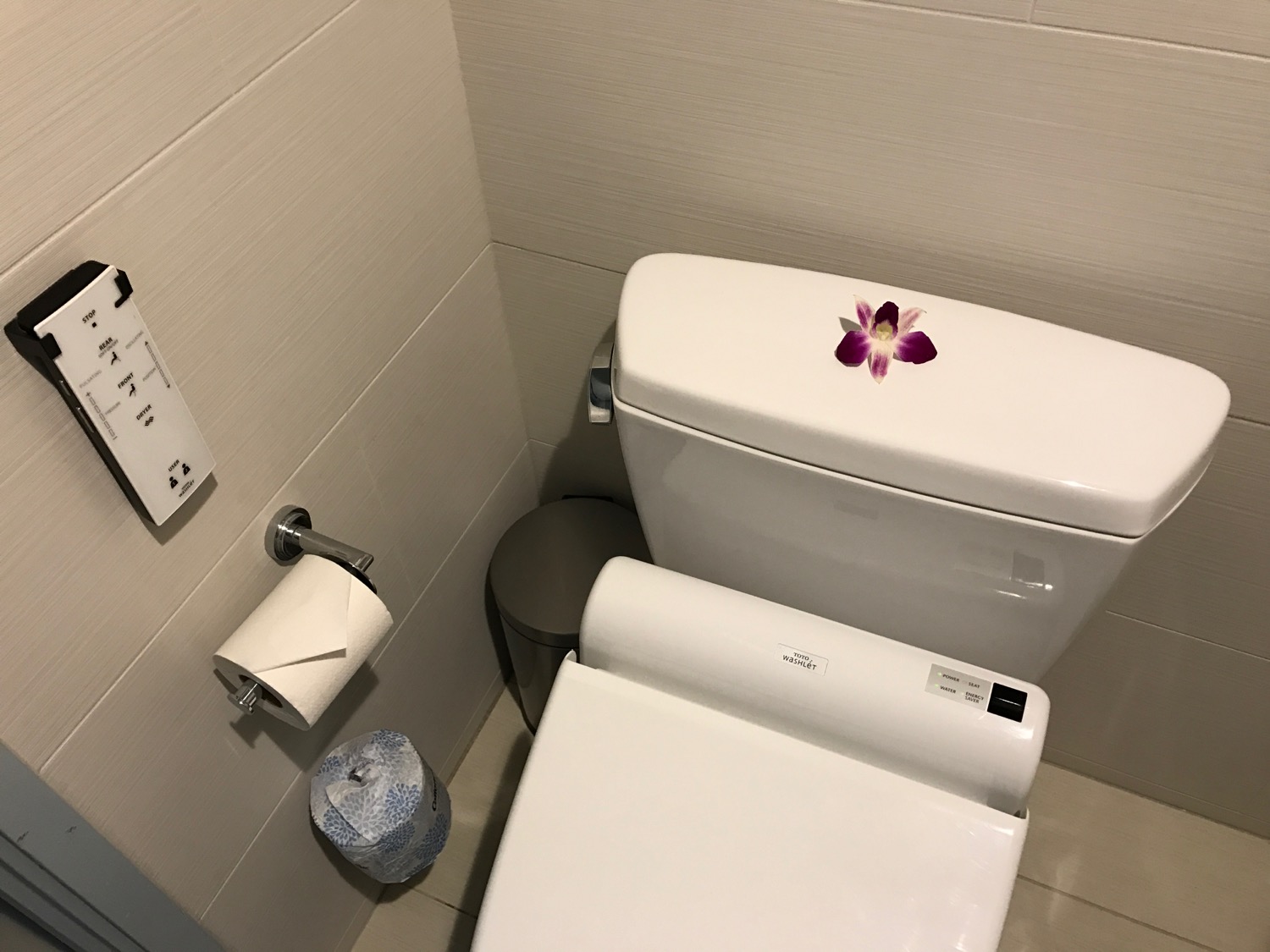 a flower on the tank of a toilet