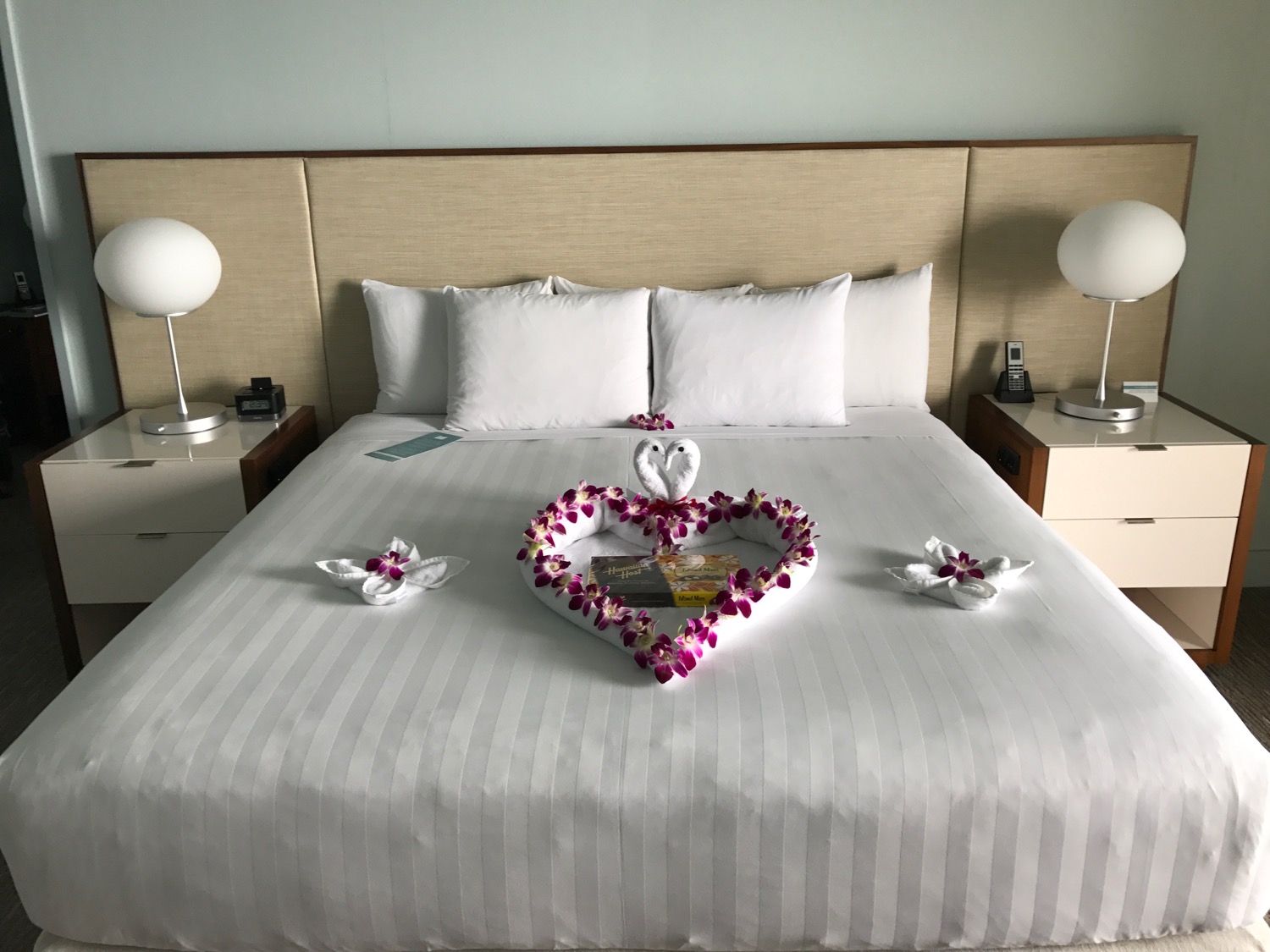 a bed with a heart shaped flower decoration