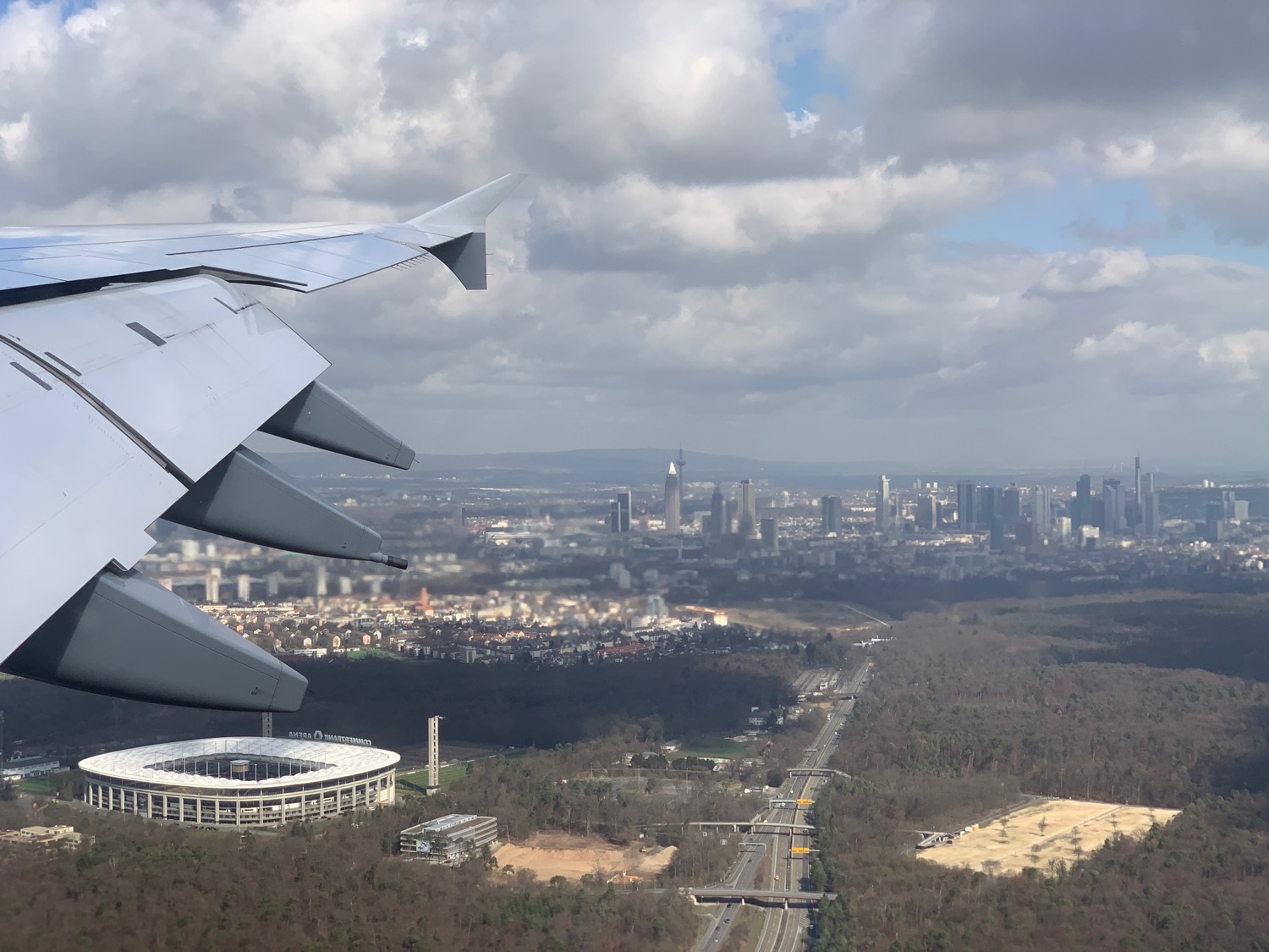 an airplane wing and city landscape