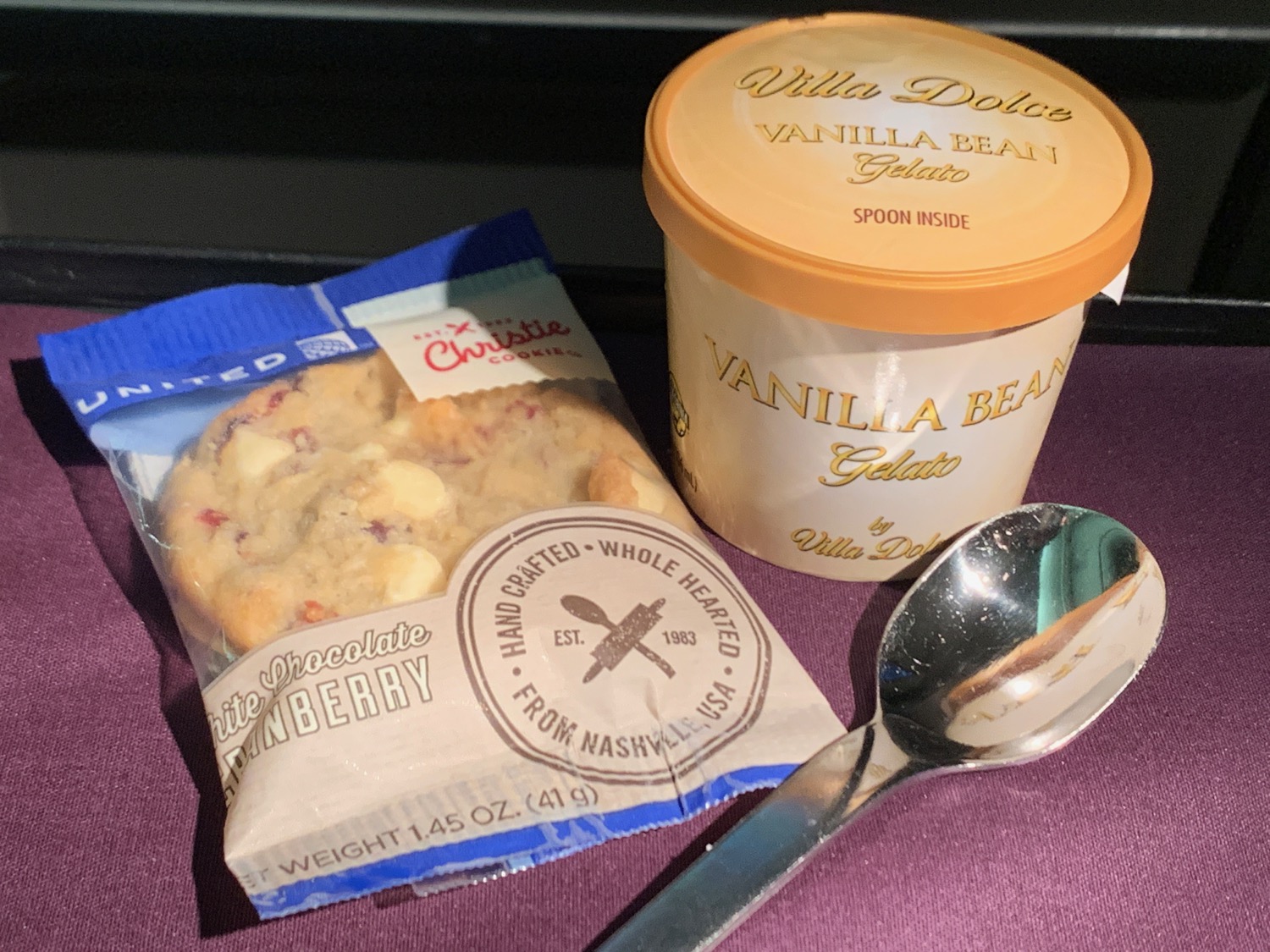 a spoon and a bag of ice cream and a cookie