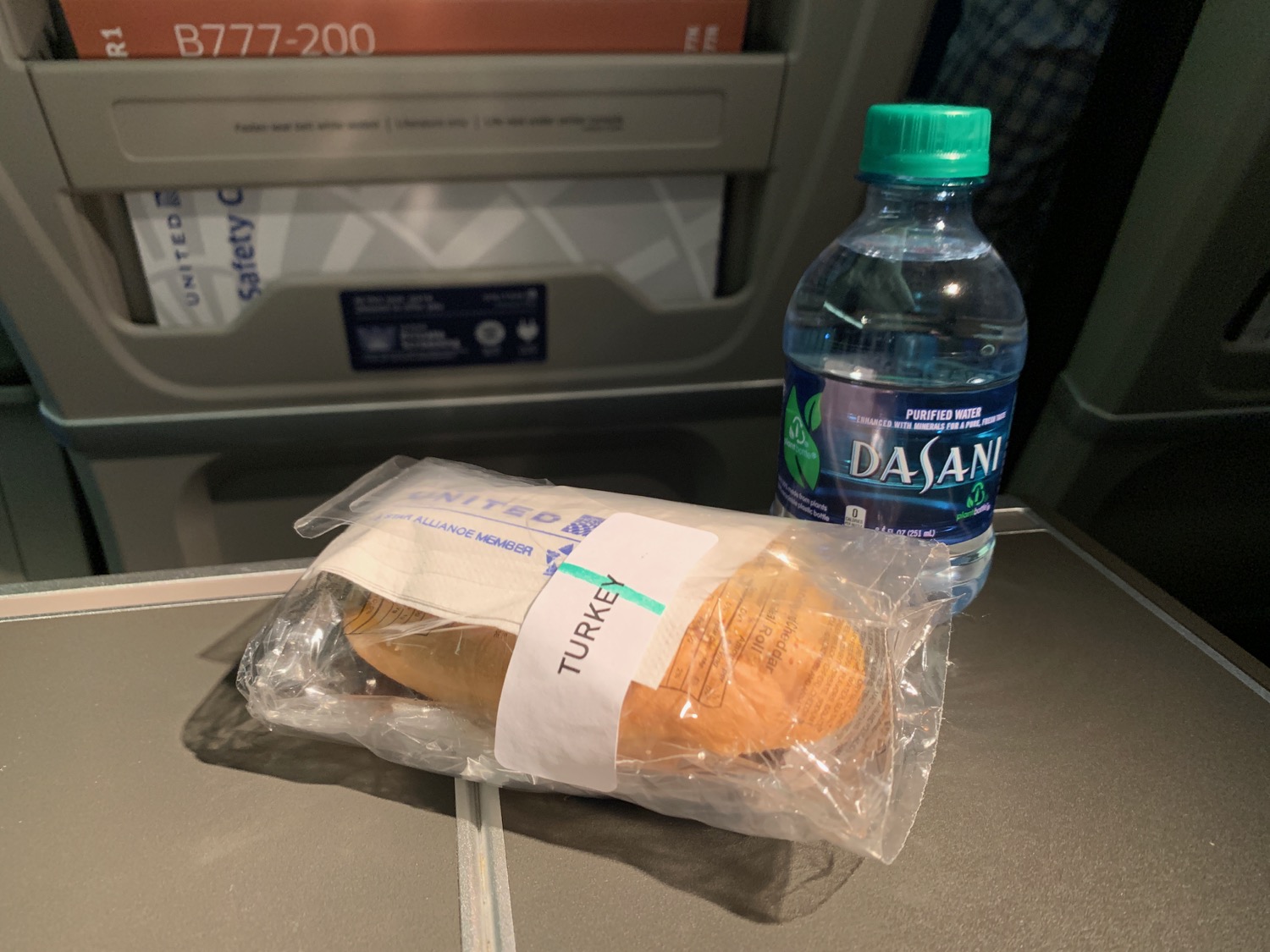a bag of bread and a water bottle on a table