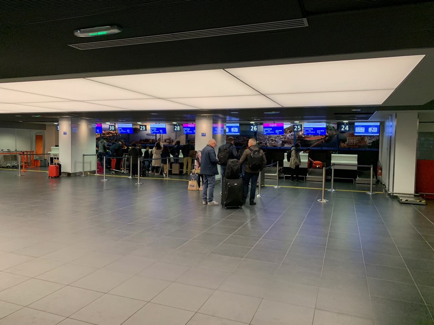 people standing in a line in a terminal