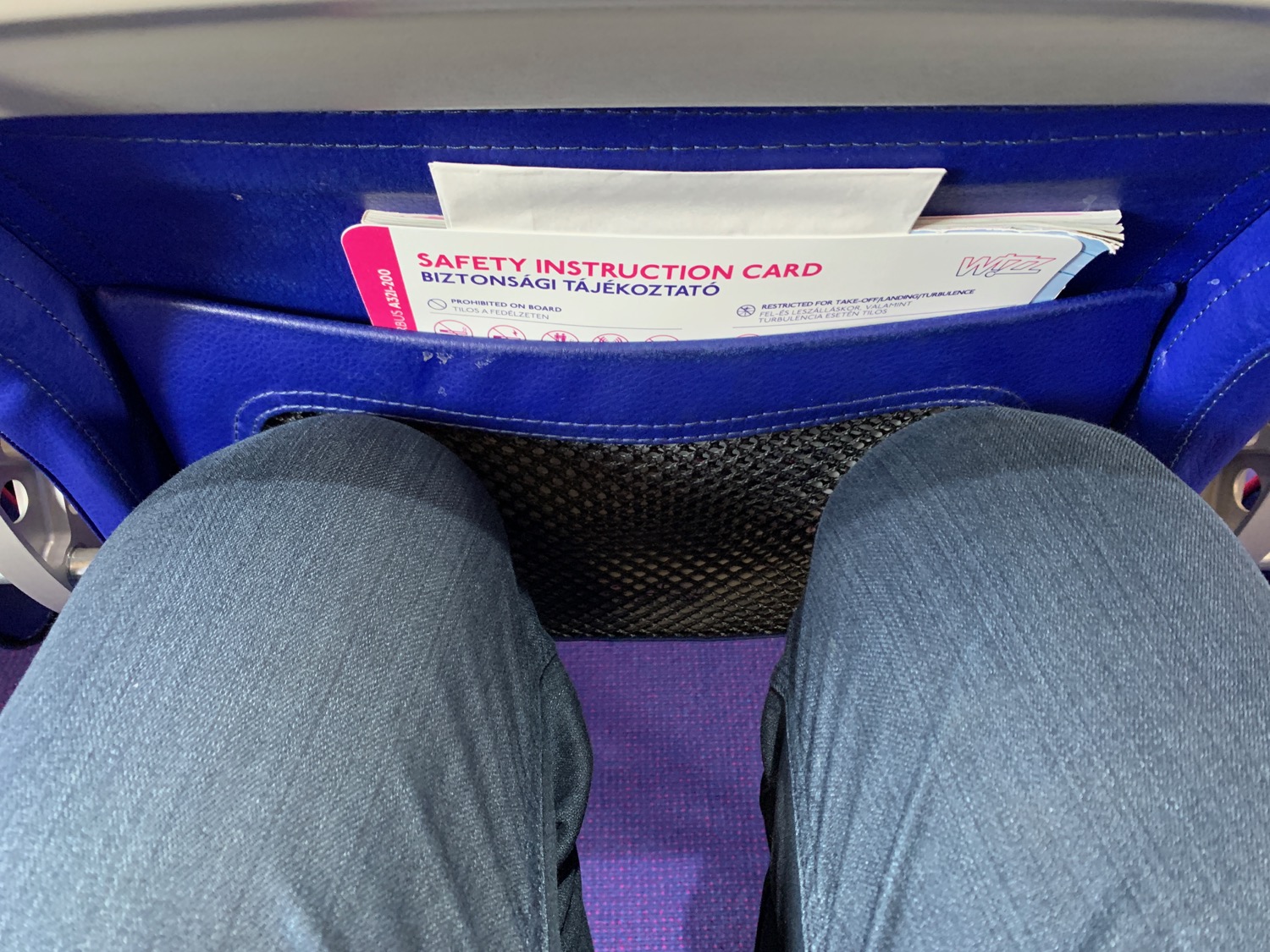 a person's legs in a blue bag with a safety instructions