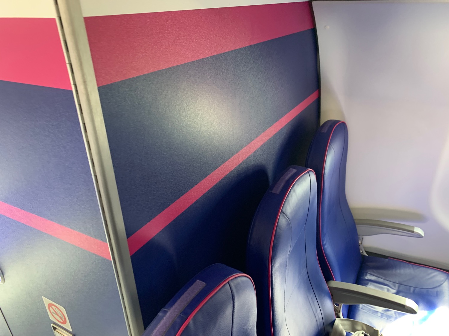 a blue and pink seats on a plane