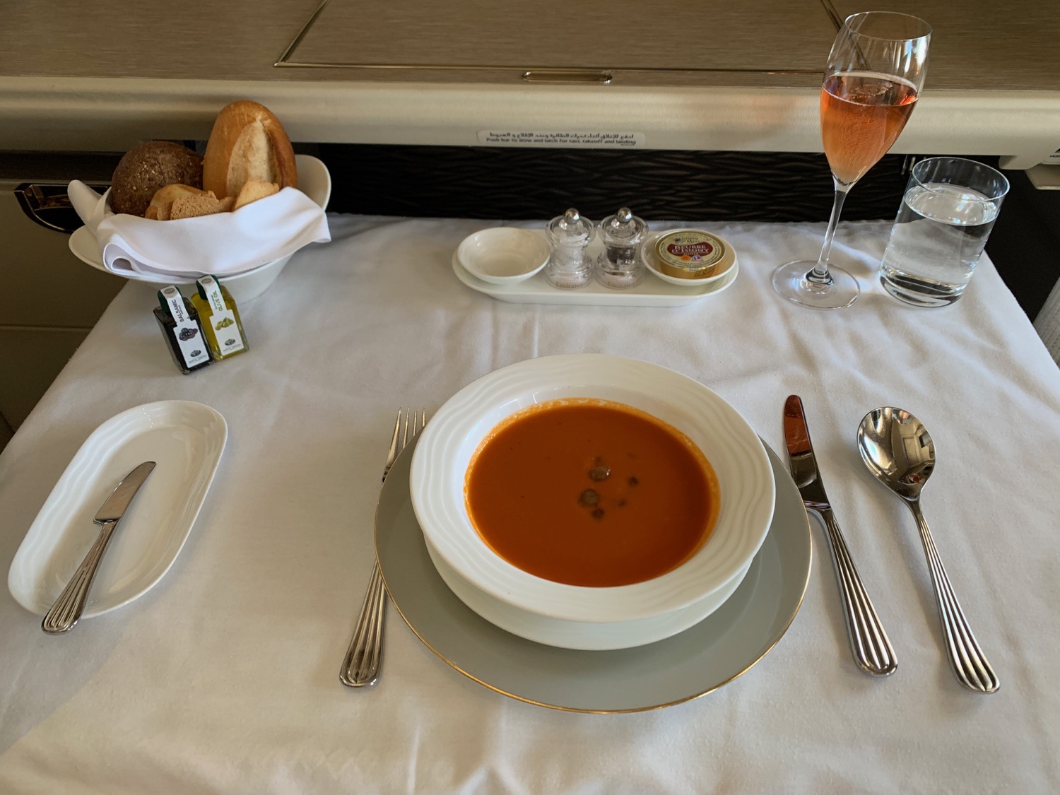 a plate of soup and silverware on a table