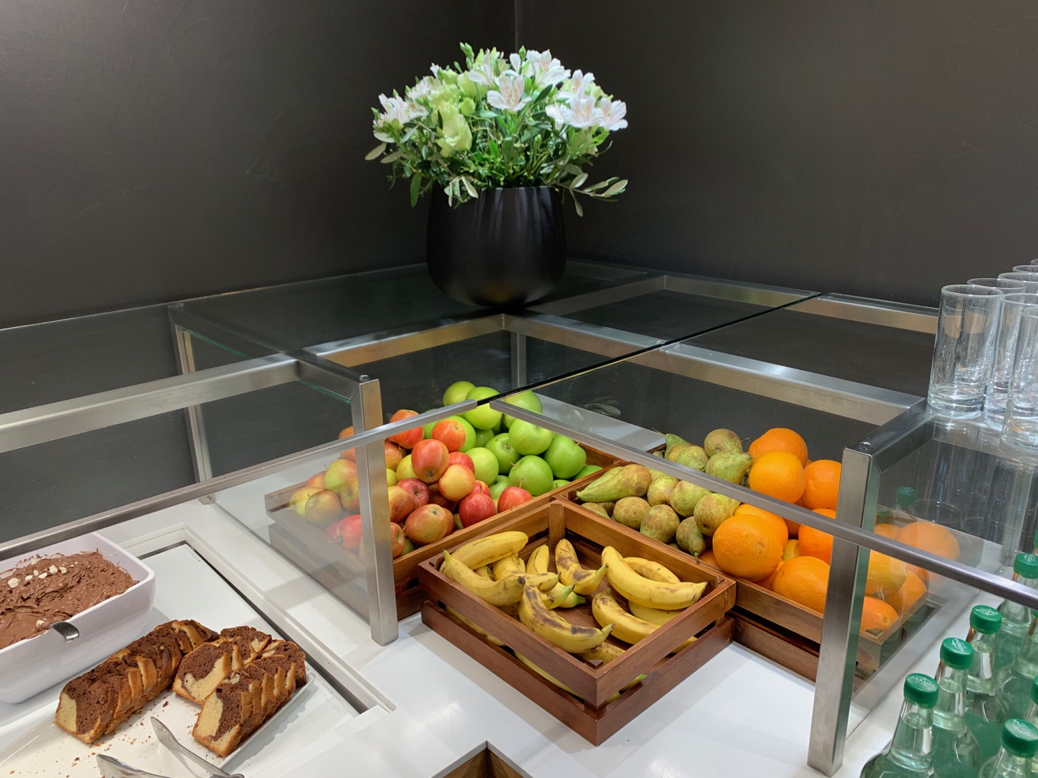 a display case of fruit and bread