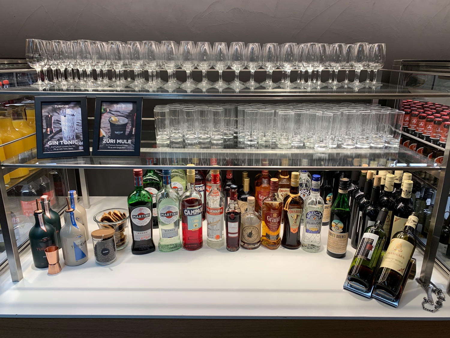 a shelf with many glasses and bottles