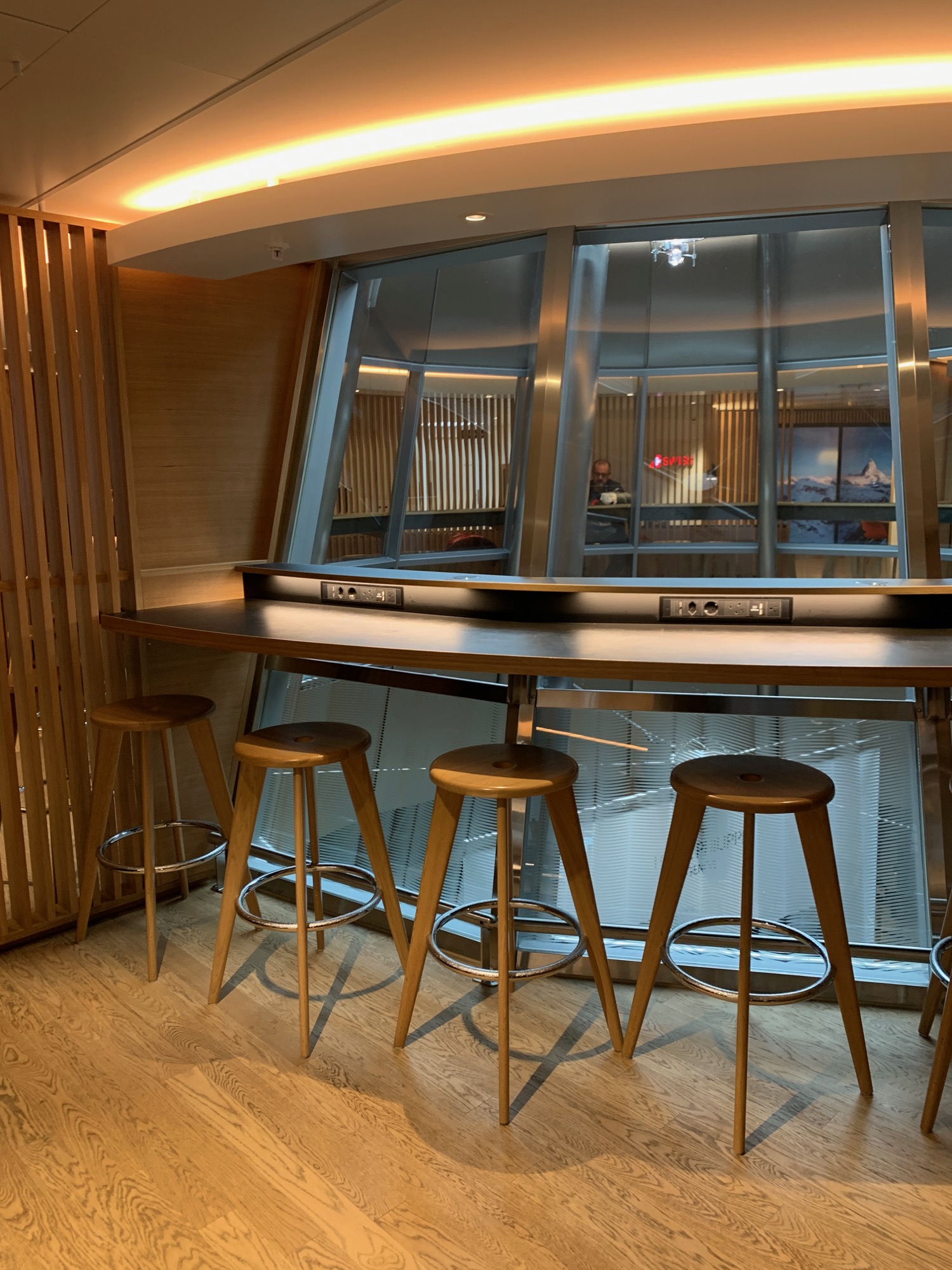 a bar with stools and a window