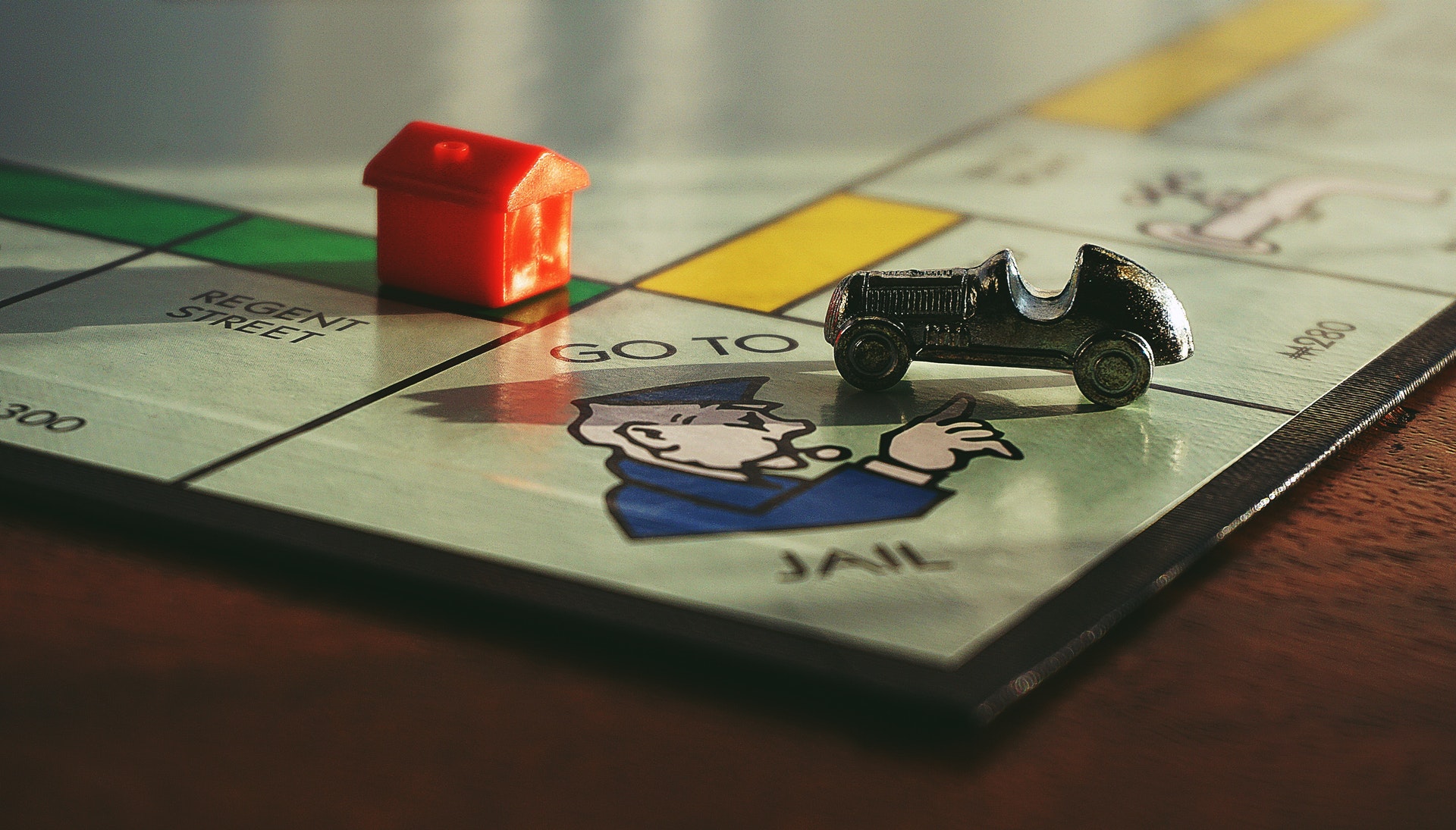 a game board with a toy car and a house