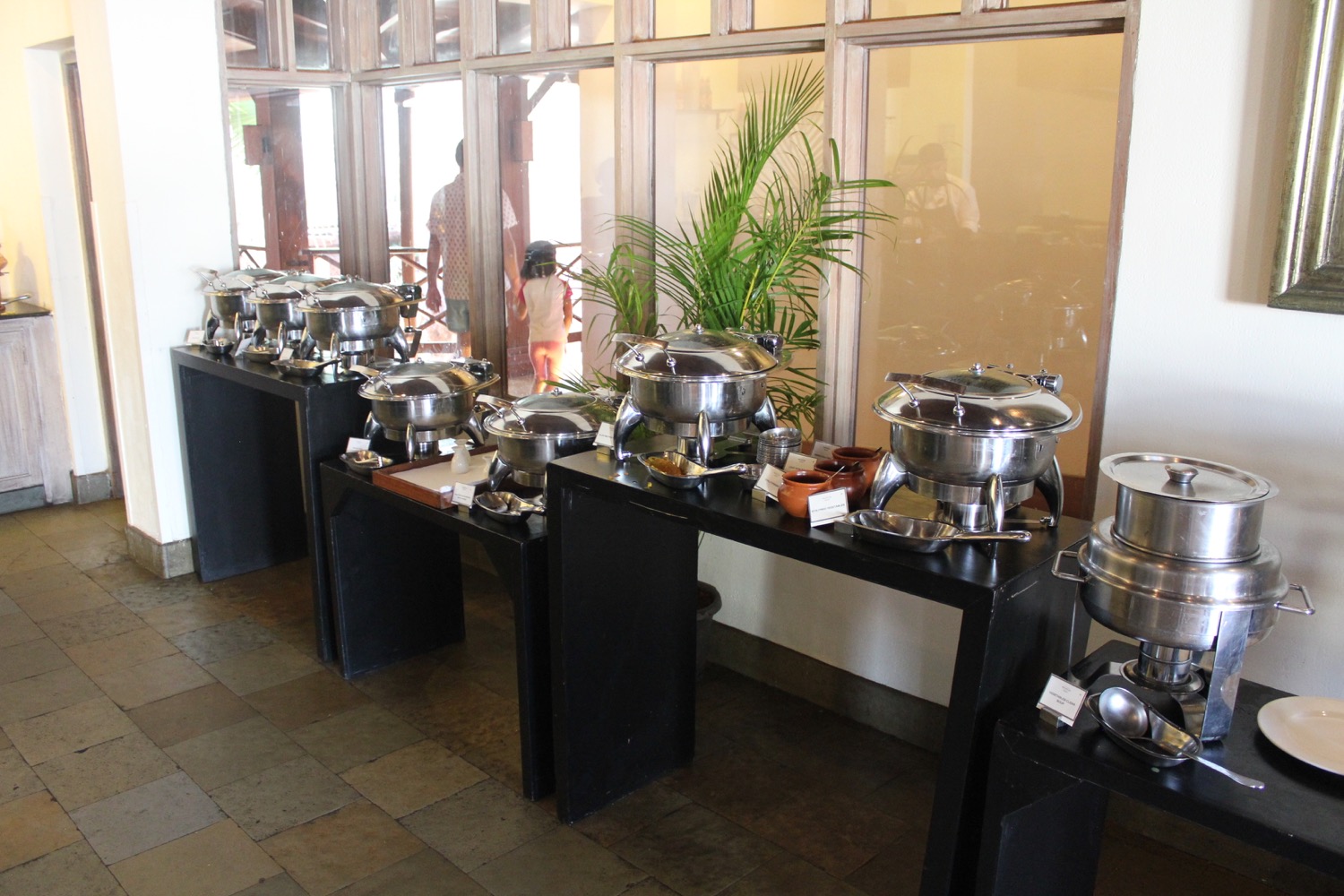 a buffet table with many silver pots