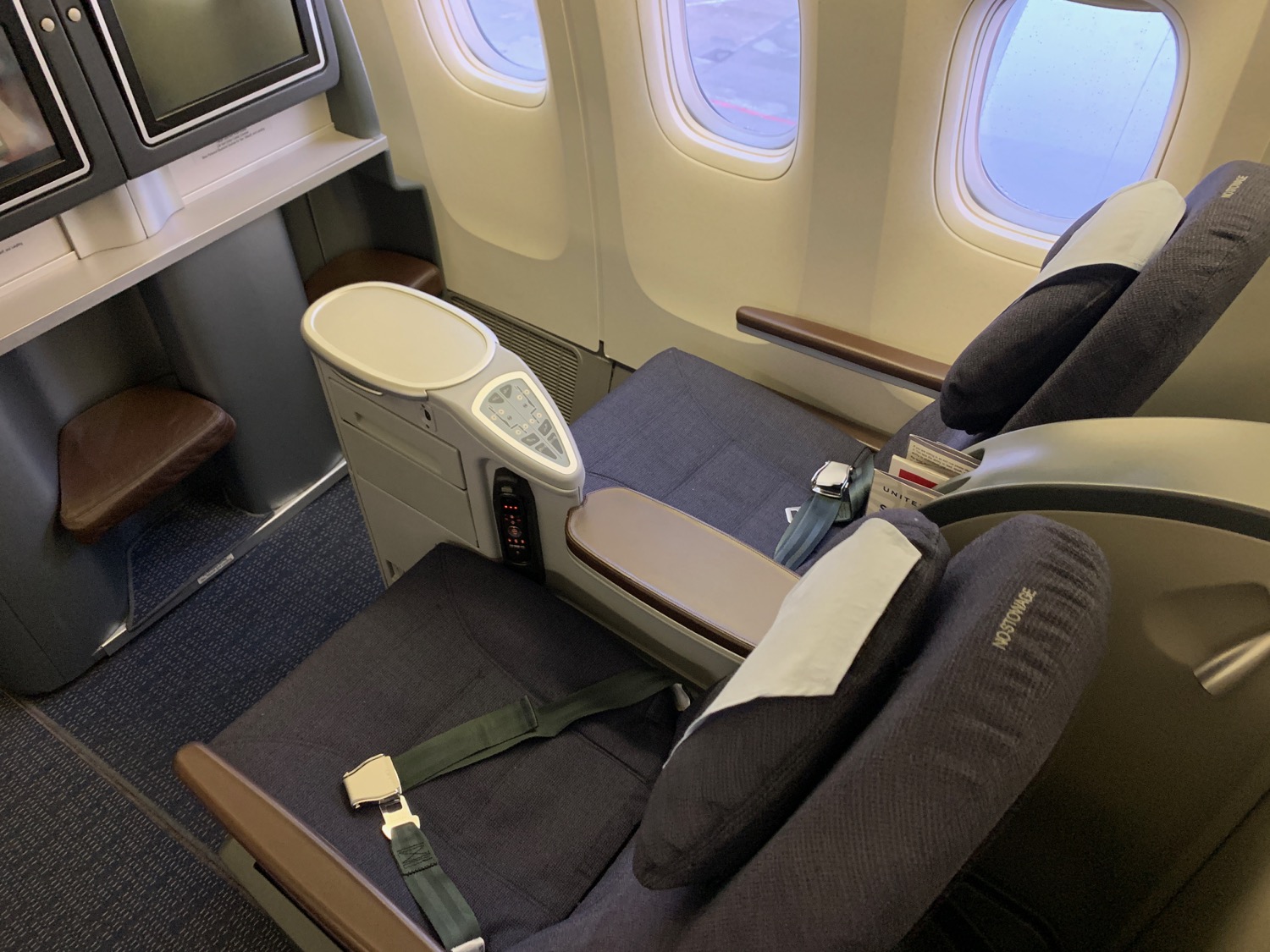 seat in an airplane with seats and a tv